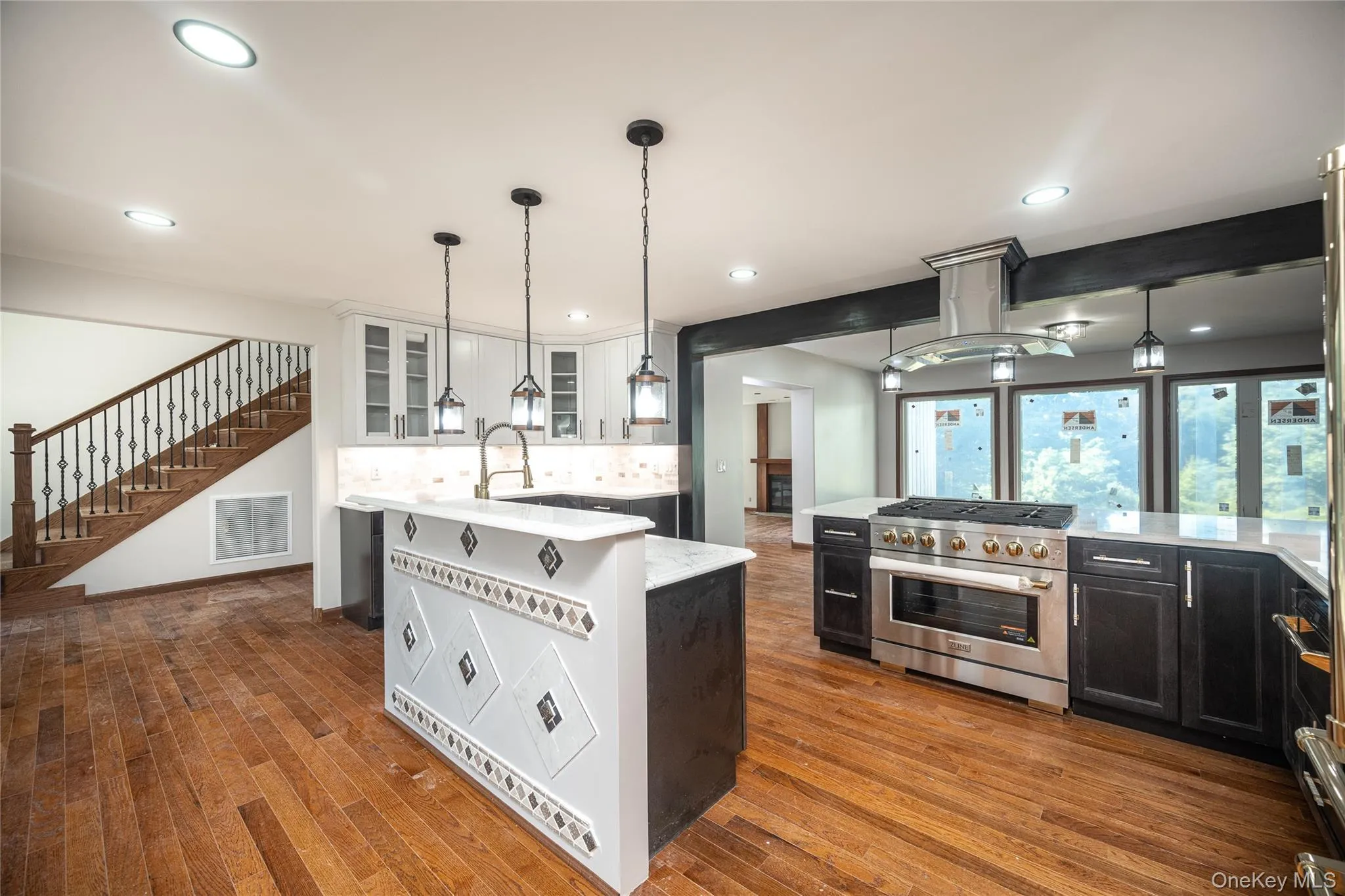 Customized center island features the sink and dishwasher and has a breakfast bar as well. Customized center island features the sink and dishwasher and has a breakfast bar as well.
