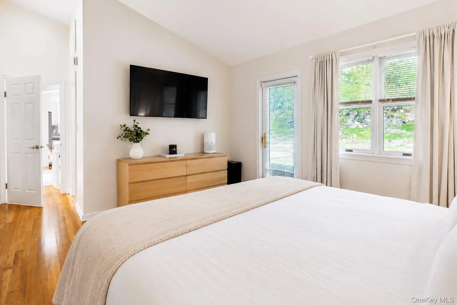 Another beautiful view of the primary bedroom showcases an abundance of natural light and a private entry door leading directly to the patio and backyard, creating a peaceful connection to the outdoors. Another beautiful view of the primary bedroom showcases an abundance of natural light and a private entry door leading directly to the patio and backyard, creating a peaceful connection to the outdoors.