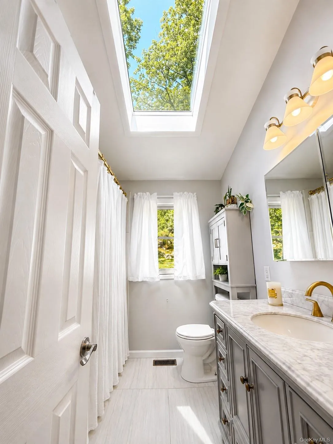 The primary bathroom is beautifully enhanced by a skylight that fills the space with natural light, creating a bright, airy atmosphere and a peaceful connection to the outdoors. The primary bathroom is beautifully enhanced by a skylight that fills the space with natural light, creating a bright, airy atmosphere and a peaceful connection to the outdoors.