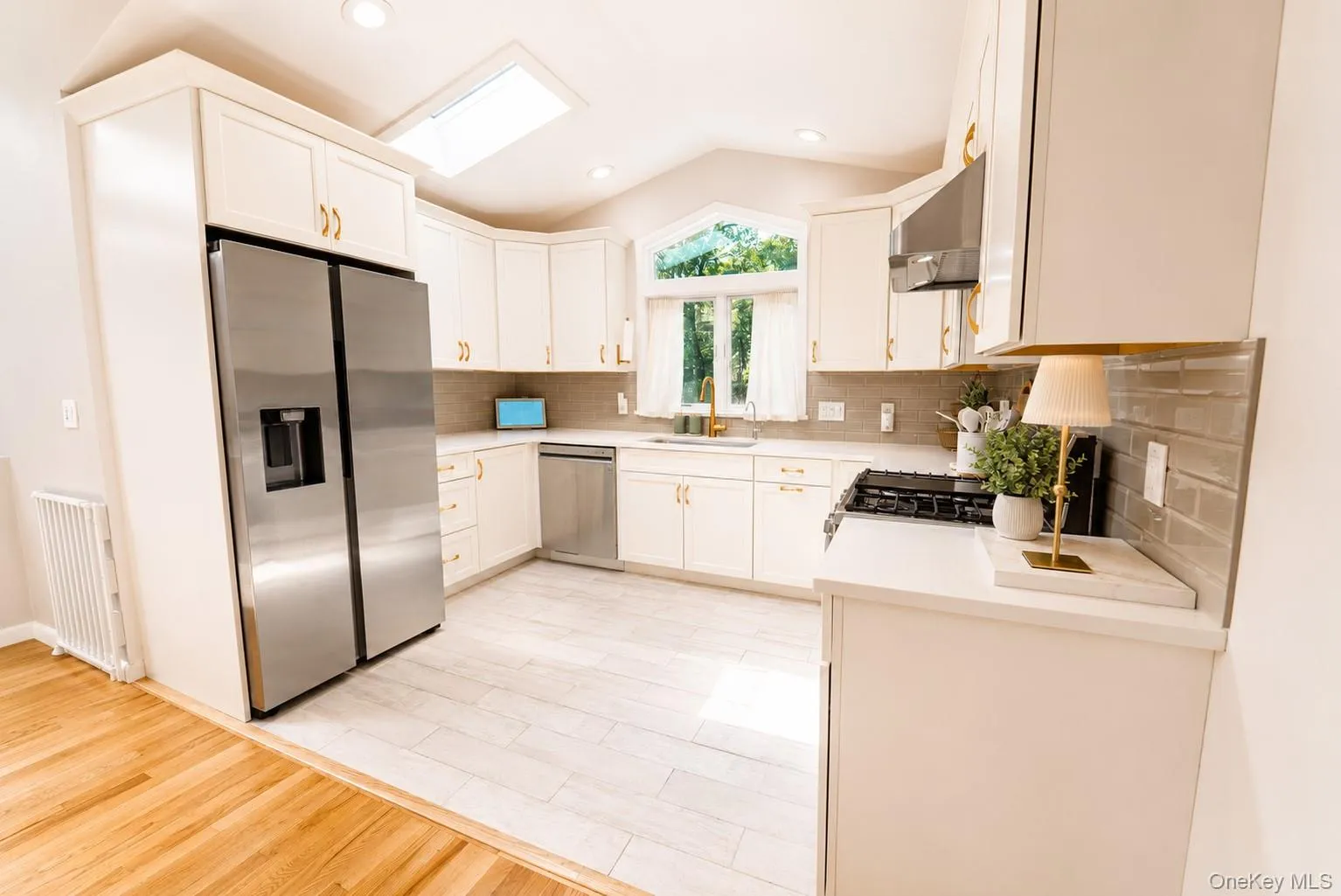 Designed with both style and functionality in mind, the kitchen features durable tile flooring and recessed lighting and a skylight that beautifully illuminates the space, creating a bright and inviting atmosphere. Designed with both style and functionality in mind, the kitchen features durable tile flooring and recessed lighting and a skylight that beautifully illuminates the space, creating a bright and inviting atmosphere.