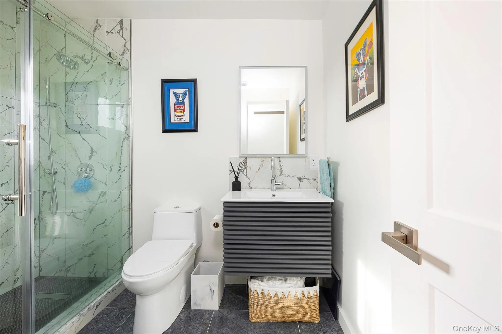 Full bath with vanity, a marble finish shower, tasteful backsplash, and tile patterned floors Full bath with vanity, a marble finish shower, tasteful backsplash, and tile patterned floors