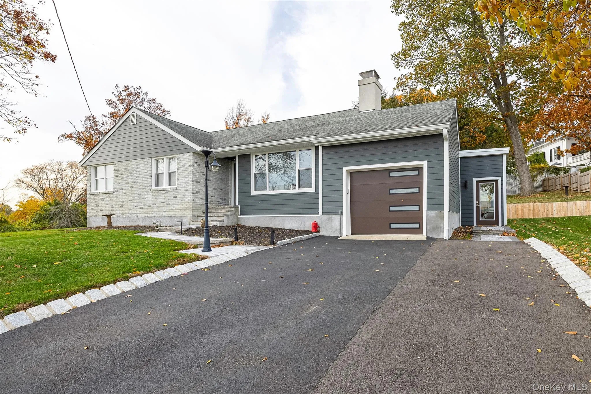 View of front of house featuring a front lawn, asphalt driveway, a chimney, a garage, and a shingled roof View of front of house featuring a front lawn, asphalt driveway, a chimney, a garage, and a shingled roof