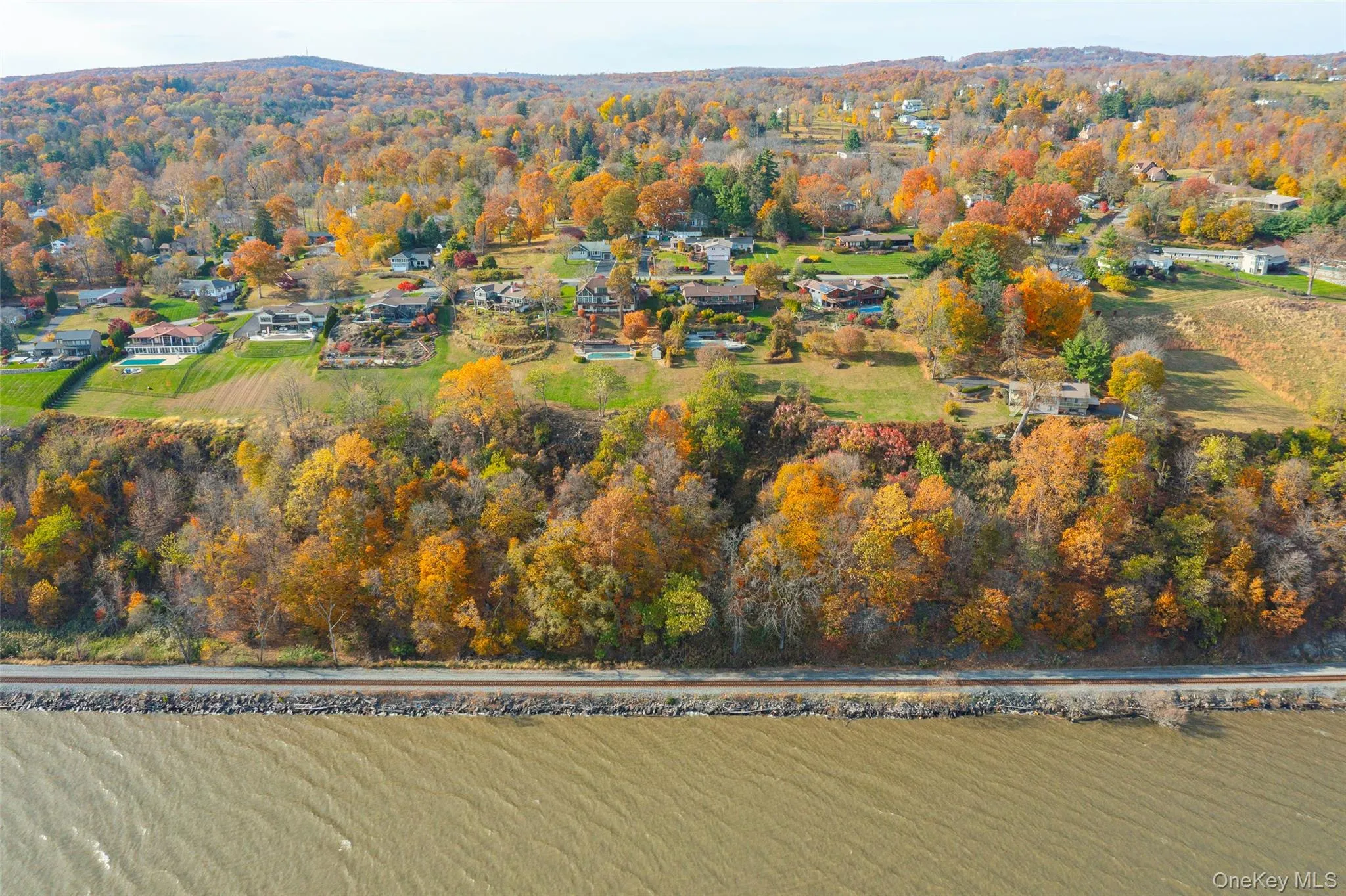 Aerial view of property's location with a forest Aerial view of property's location with a forest