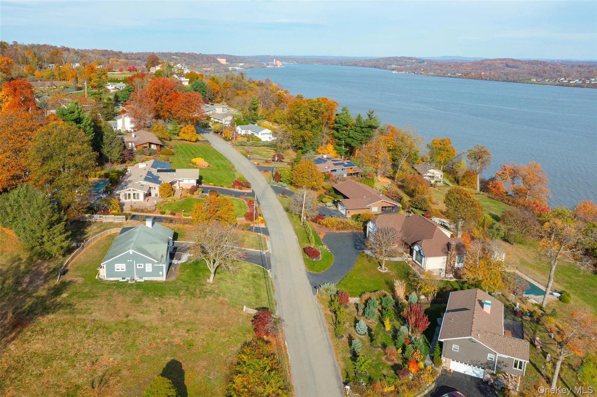Aerial overview of property's location featuring nearby suburban area and a nearby body of water Aerial overview of property's location featuring nearby suburban area and a nearby body of water