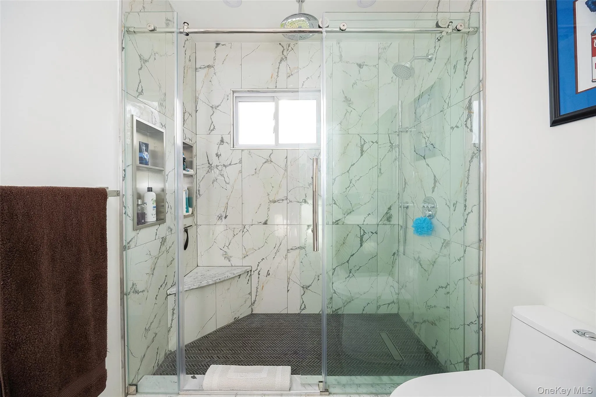 Full bathroom featuring a marble finish shower and toilet Full bathroom featuring a marble finish shower and toilet