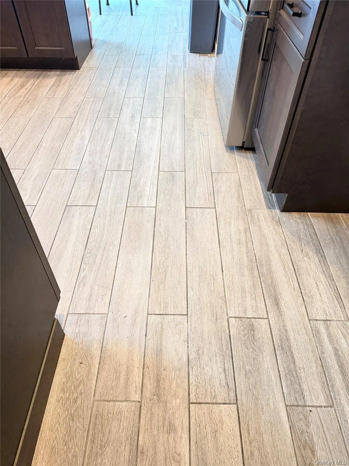 Granite tile flooring throughout the space, complemented by dark wood cabinetry and a stainless steel appliances. Granite tile flooring throughout the space, complemented by dark wood cabinetry and a stainless steel appliances.