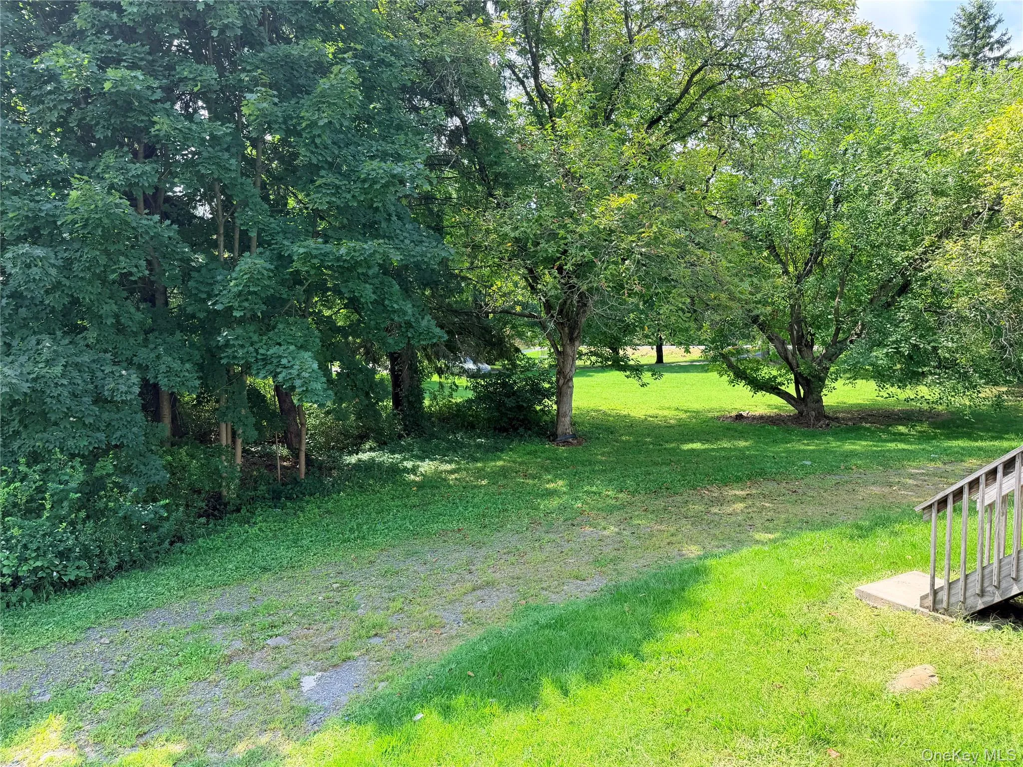 Side view. Continuation of driveway to enter the back of the home. Side view. Continuation of driveway to enter the back of the home.
