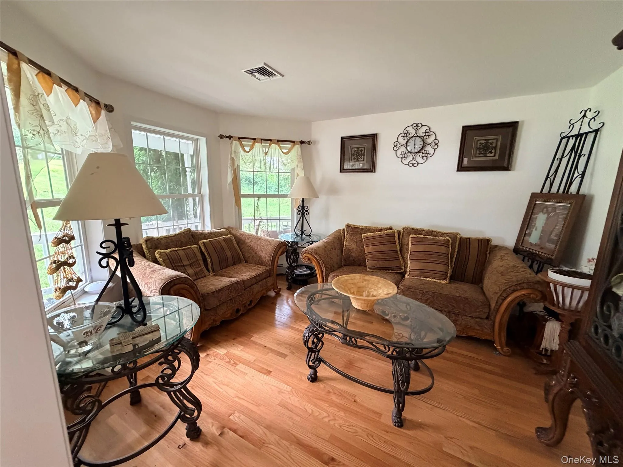 Hardwood flooring, multiple windows, white painted walls, and recessed lighting Hardwood flooring, multiple windows, white painted walls, and recessed lighting