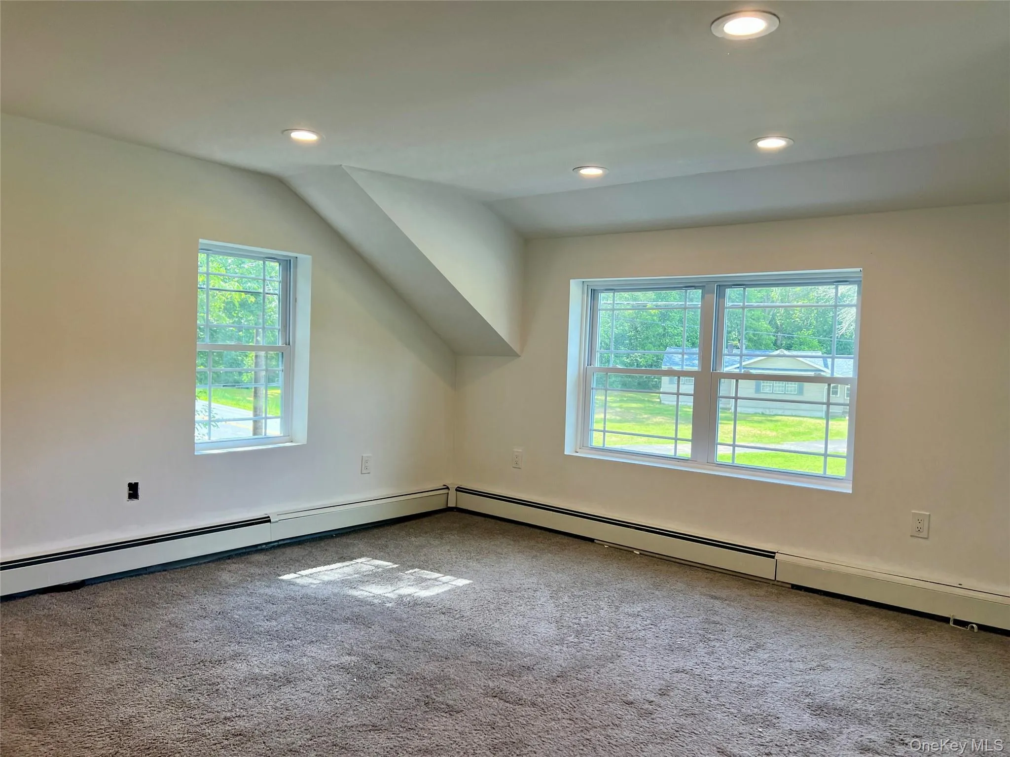 Additional living space with carpet, recessed lighting, and baseboard heating Additional living space with carpet, recessed lighting, and baseboard heating
