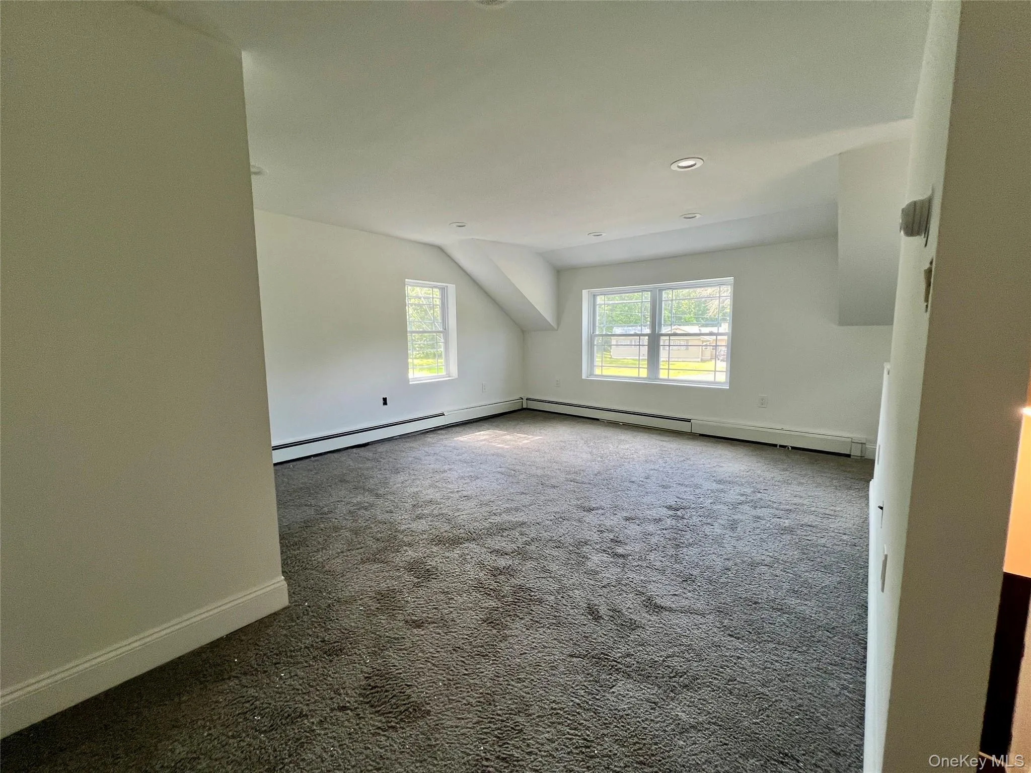 Carpeted spare room featuring baseboards and recessed lighting Carpeted spare room featuring baseboards and recessed lighting