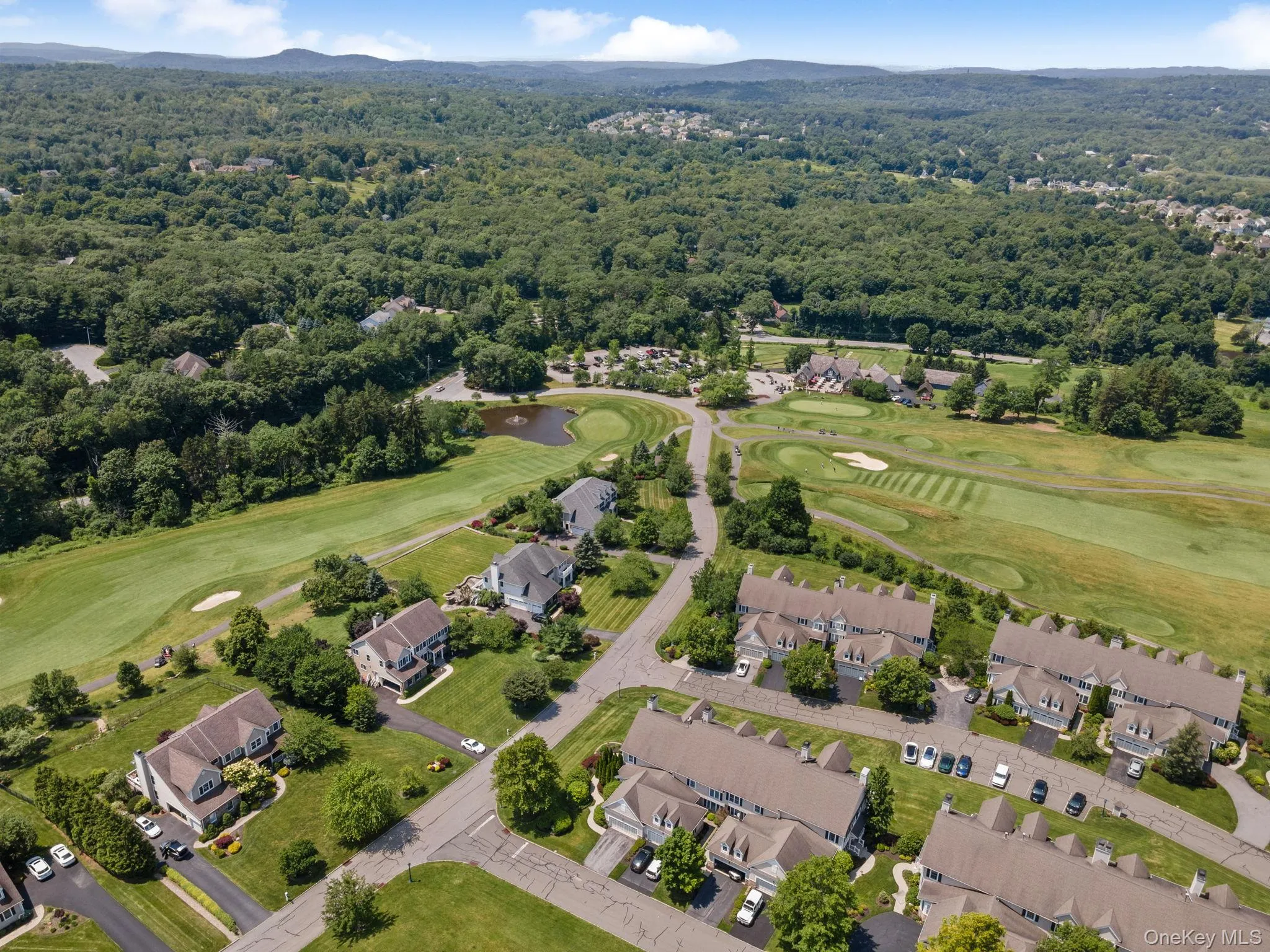 View of property location featuring a golf course and nearby suburban area View of property location featuring a golf course and nearby suburban area