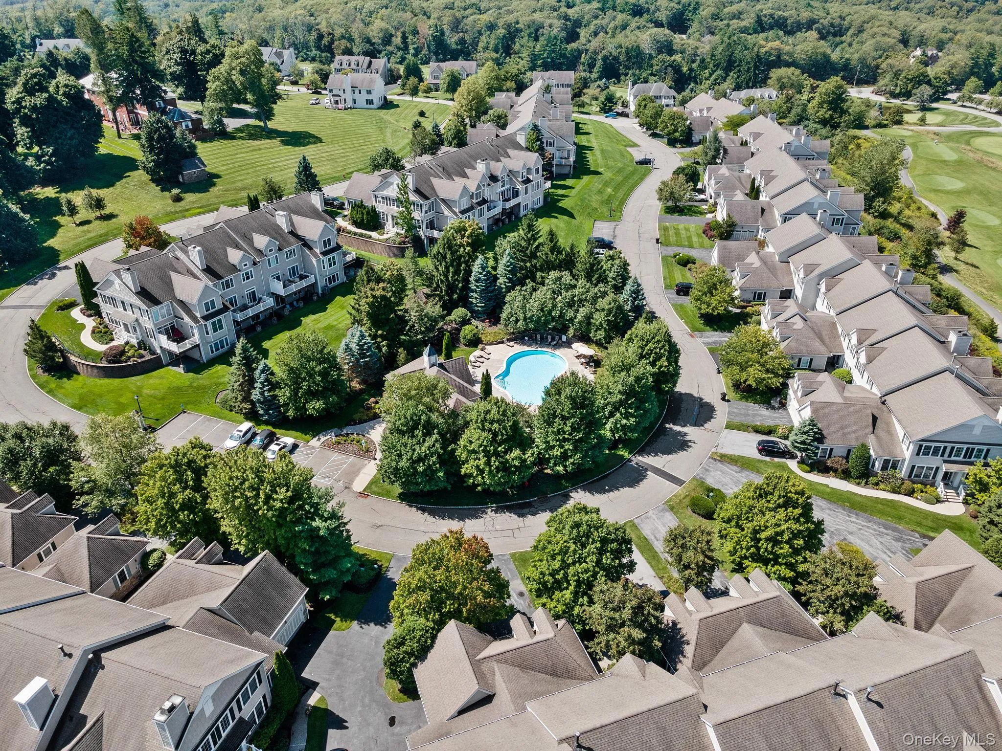 Aerial perspective of suburban area with a pool area Aerial perspective of suburban area with a pool area