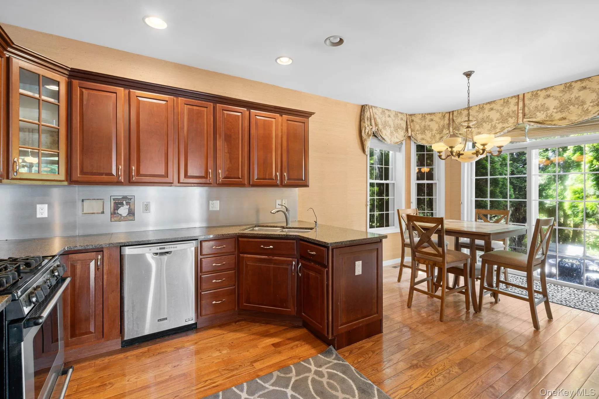 Kitchen featuring appliances with stainless steel finishes, a chandelier, light wood-type flooring, healthy amount of natural light, and recessed lighting Kitchen featuring appliances with stainless steel finishes, a chandelier, light wood-type flooring, healthy amount of natural light, and recessed lighting