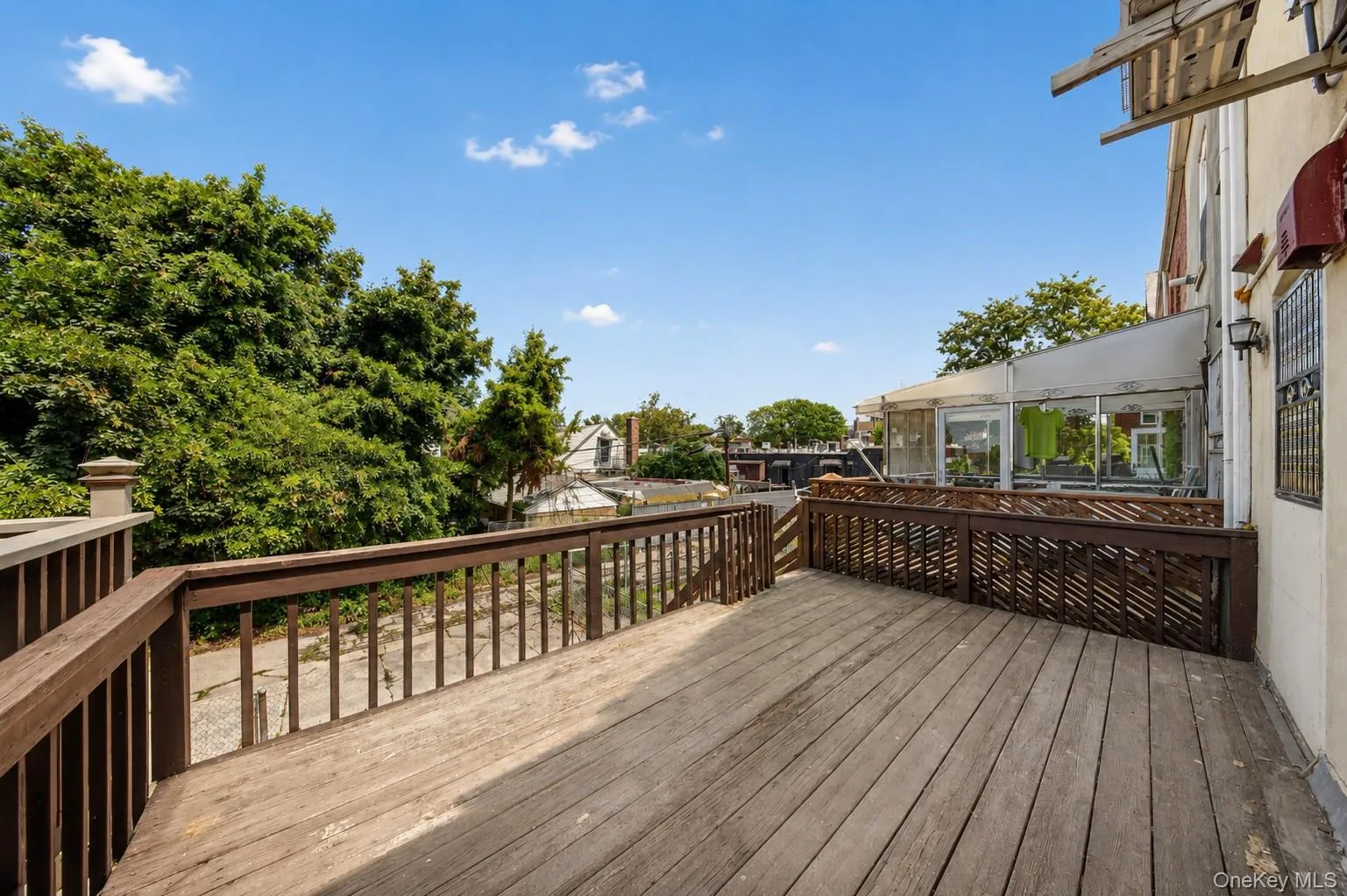 Expansive wood deck with wood railings and privacy lattice Expansive wood deck with wood railings and privacy lattice