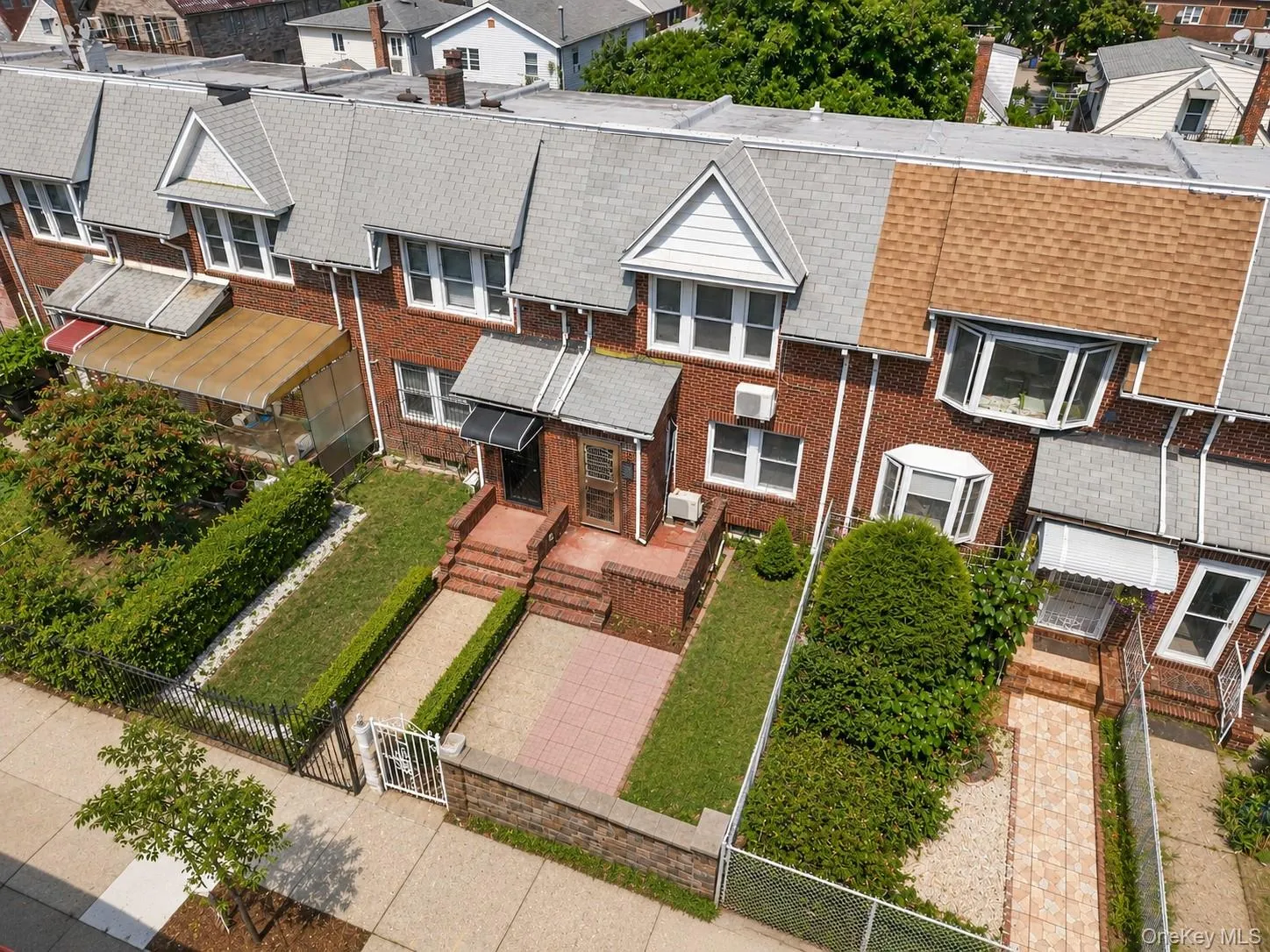 Brick exterior with multiple dormer windows Brick exterior with multiple dormer windows