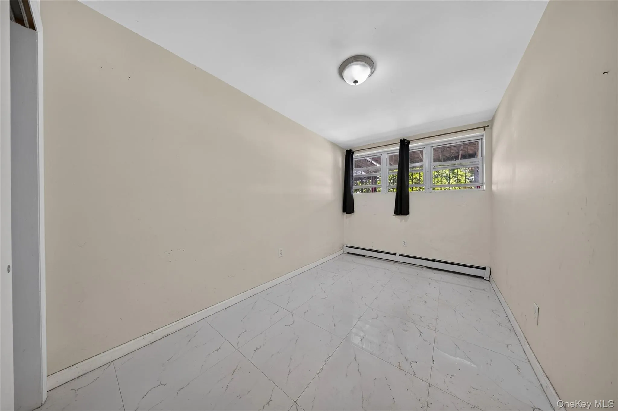White tile flooring with subtle gray veining White tile flooring with subtle gray veining