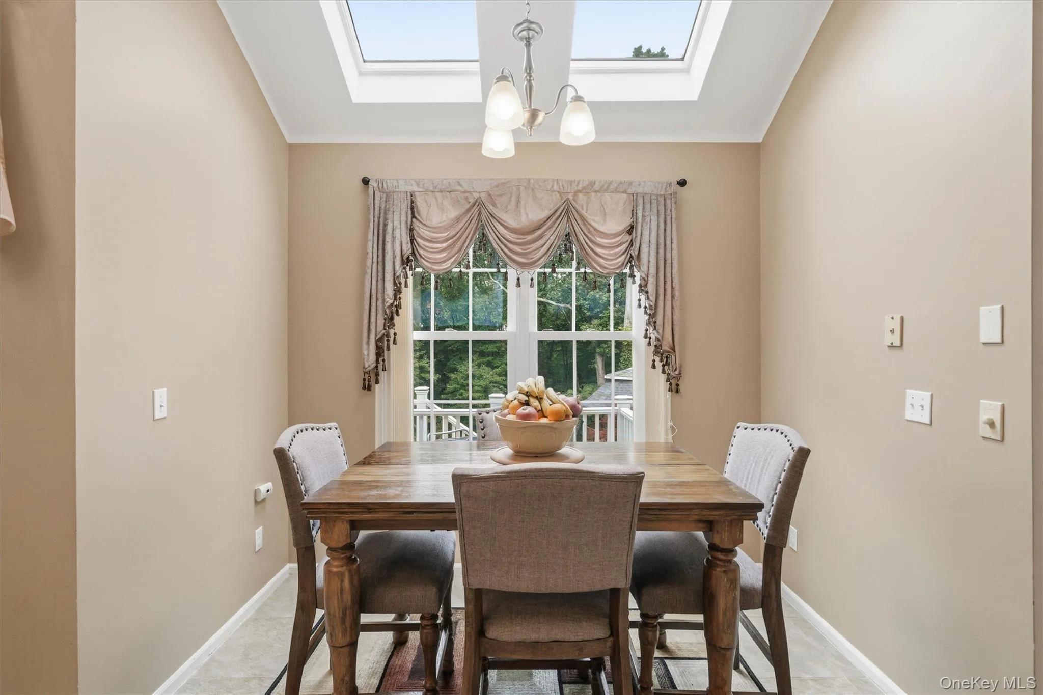The dining area with large windows and skylights. The dining area with large windows and skylights.