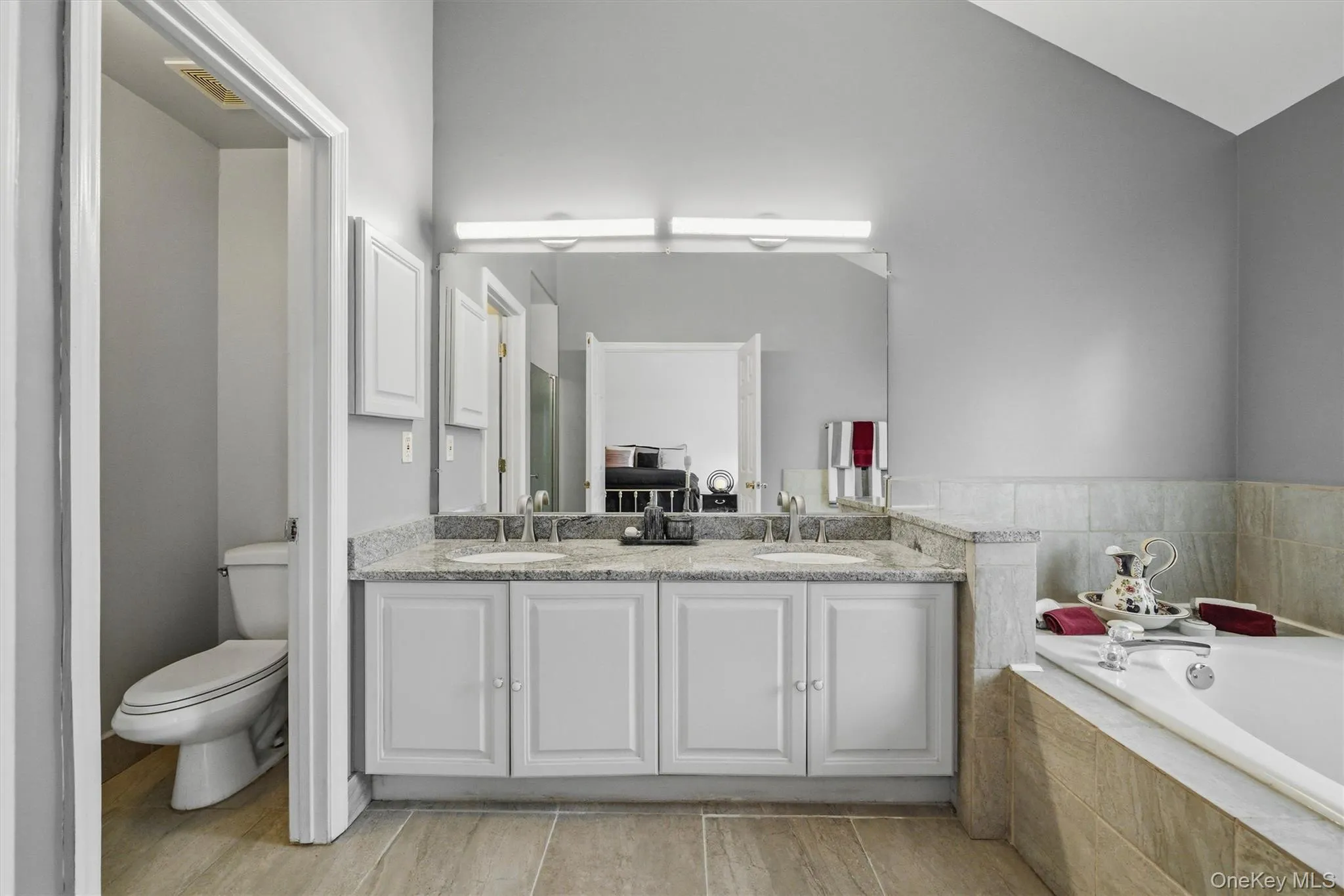 The primary bathroom features a jetted tub, shower, double sink and toilet room. The primary bathroom features a jetted tub, shower, double sink and toilet room.