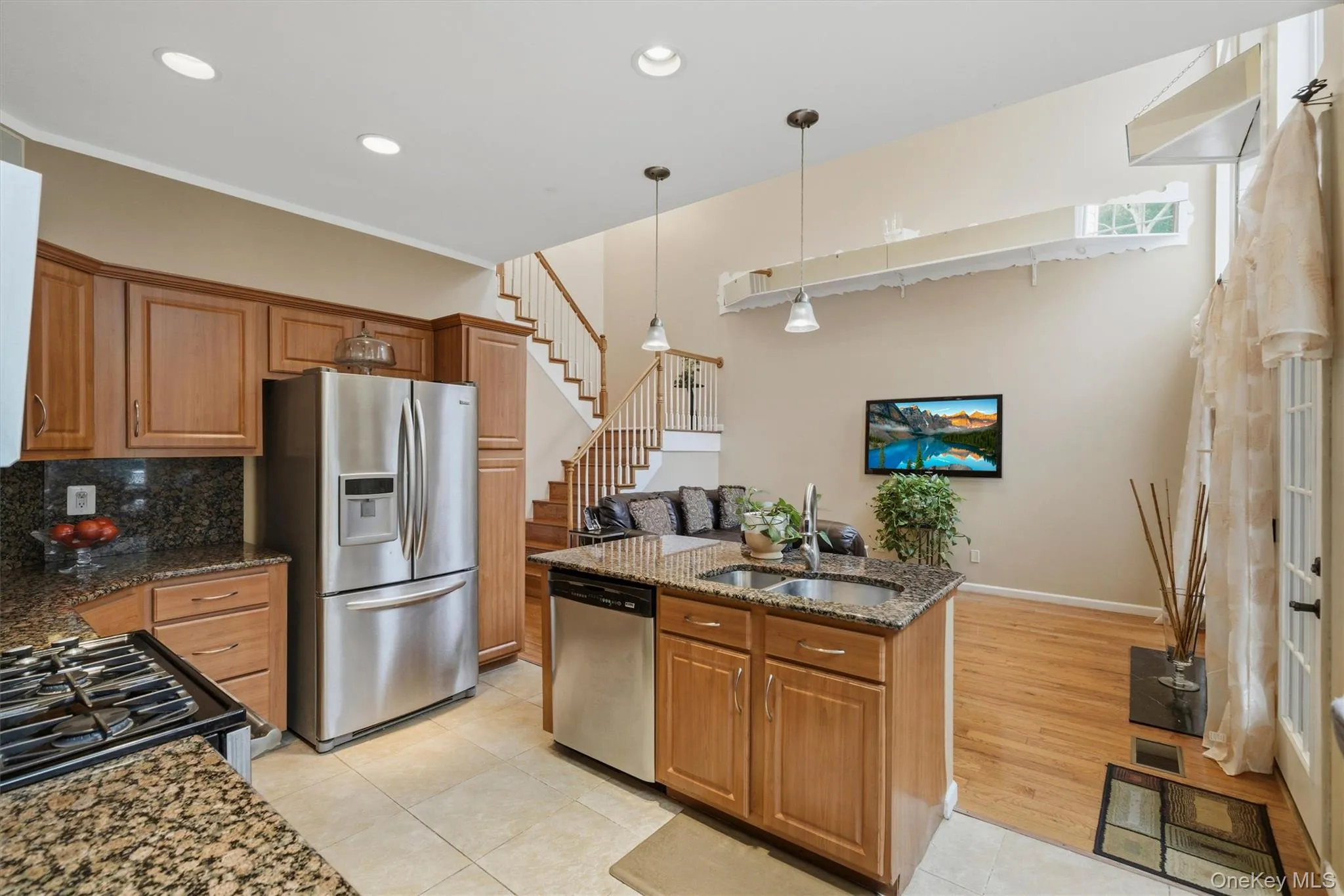 The custom kitchen opens to the family room. The island offers work space and seating. The custom kitchen opens to the family room. The island offers work space and seating.
