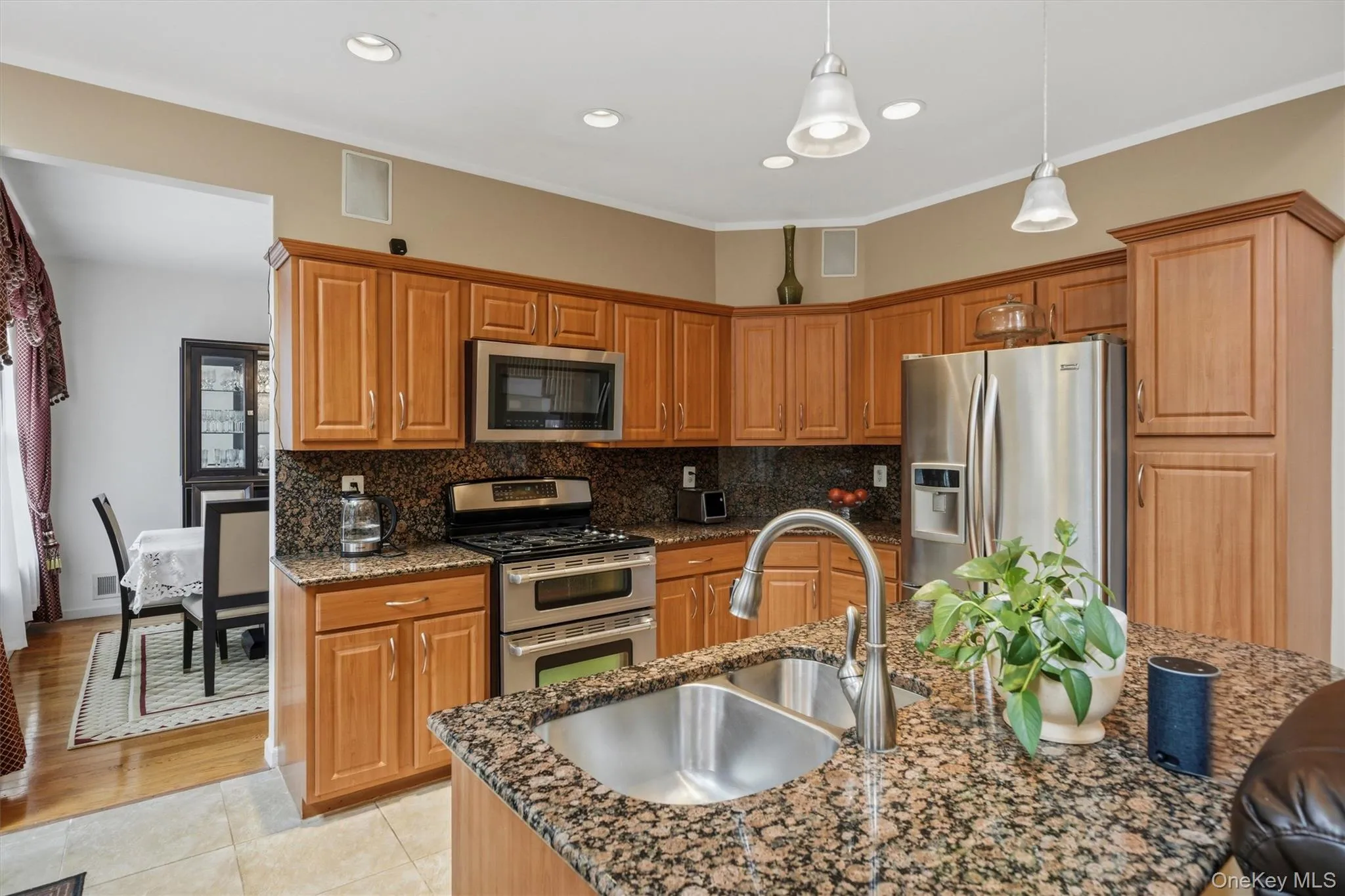 Custom cabinets, stainless steel appliances, tile flooring and granite countertops accent the updated kitchen. Custom cabinets, stainless steel appliances, tile flooring and granite countertops accent the updated kitchen.