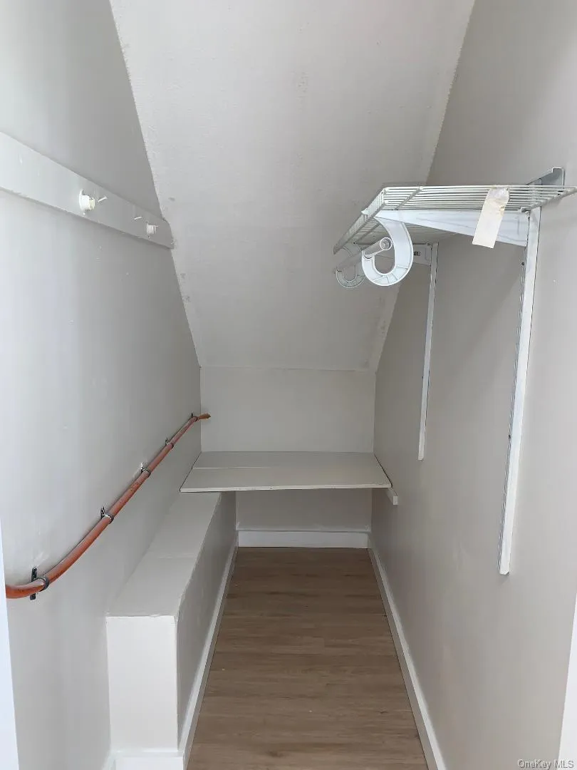Deep storage closet featuring light wood finished floors Deep storage closet featuring light wood finished floors