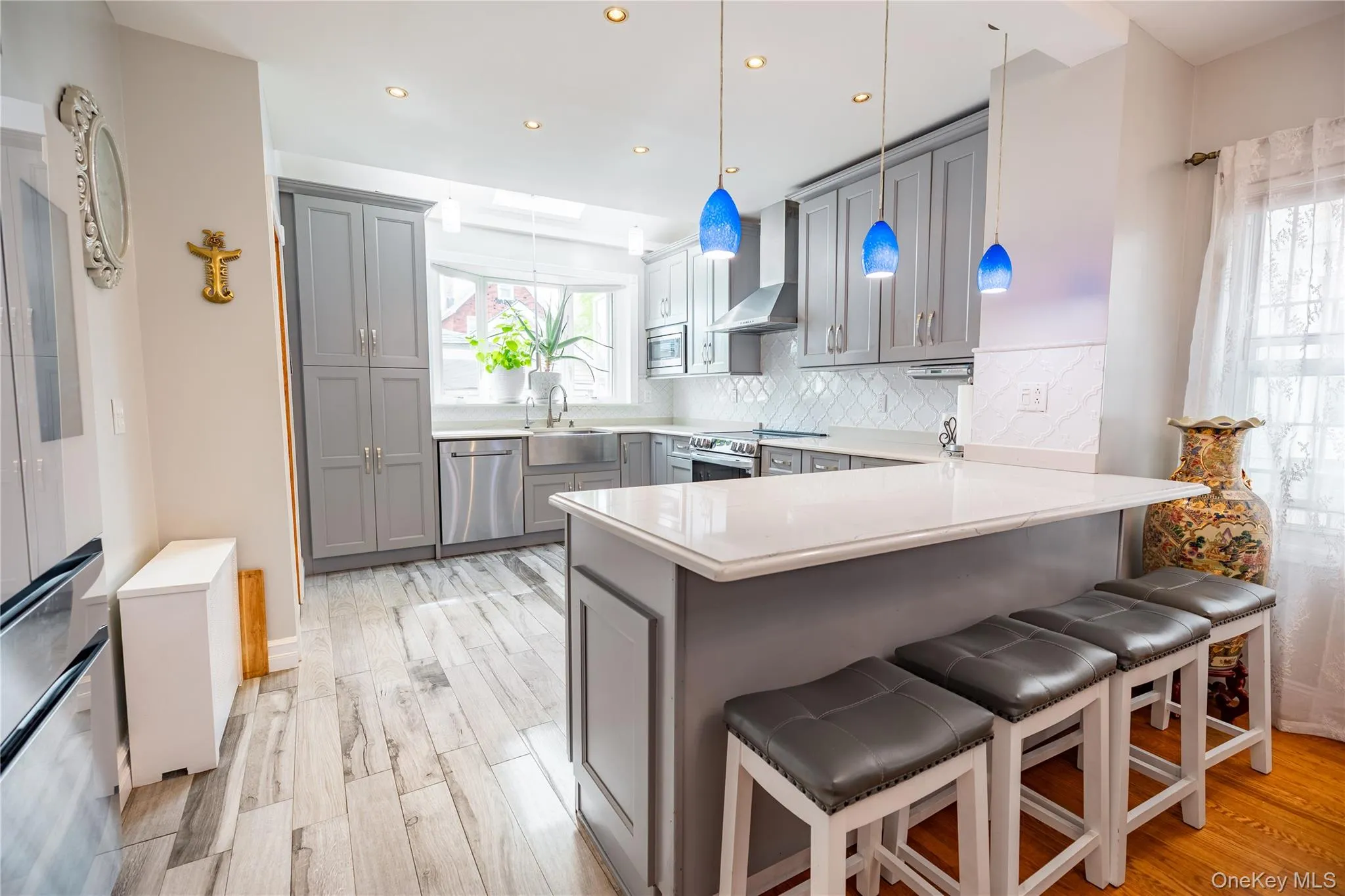 Kitchen featuring wood-finish flooring, recessed lighting, and a skylight Kitchen featuring wood-finish flooring, recessed lighting, and a skylight
