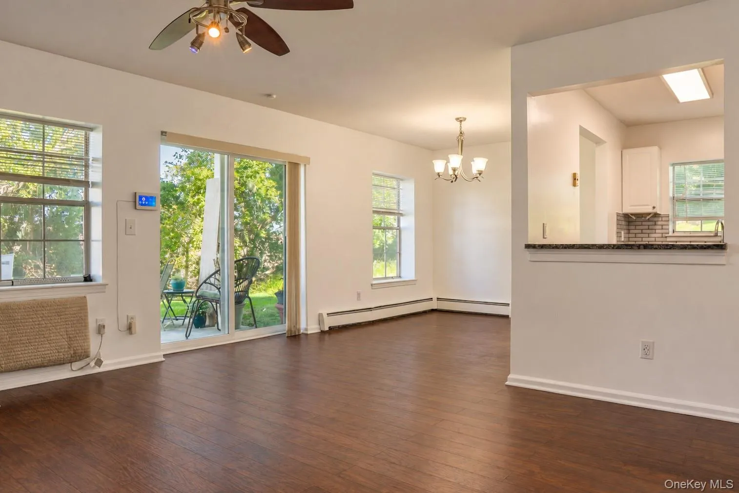 The living room flows seamlessly to the dining area, with a pass-through window to the kitchen. The living room flows seamlessly to the dining area, with a pass-through window to the kitchen.