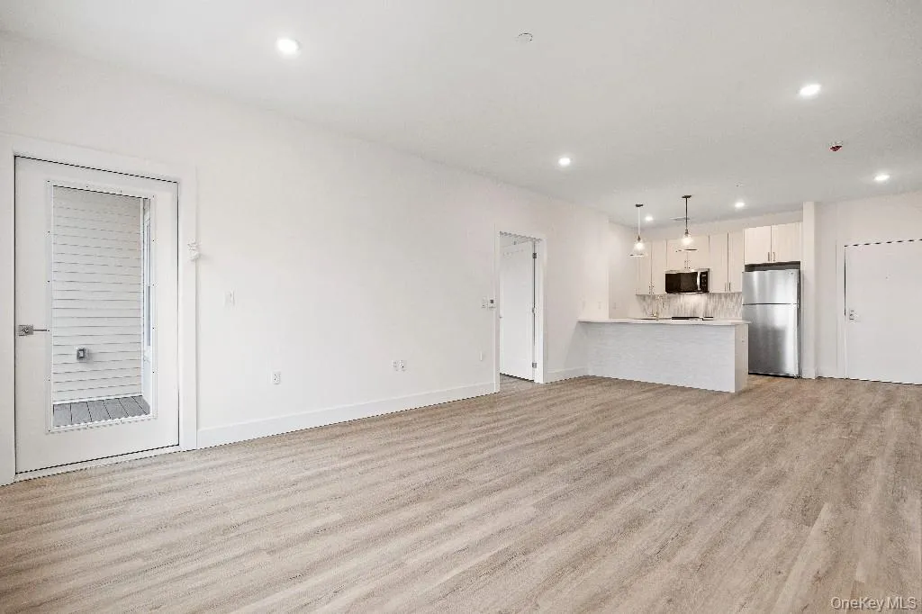 Unfurnished living room with light hardwood / wood-style floors Unfurnished living room with light hardwood / wood-style floors