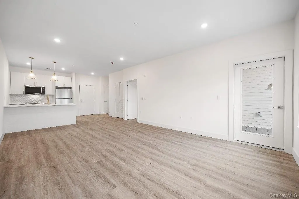 Unfurnished living room featuring light hardwood / wood-style floors Unfurnished living room featuring light hardwood / wood-style floors