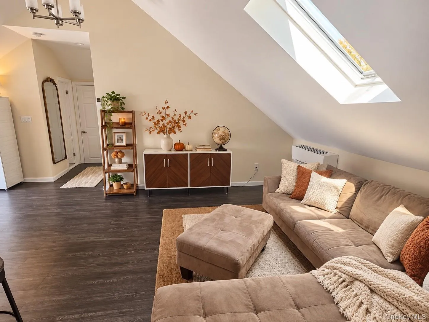 Spacious living room with stunning skylight enveloping the room with natural light. Spacious living room with stunning skylight enveloping the room with natural light.