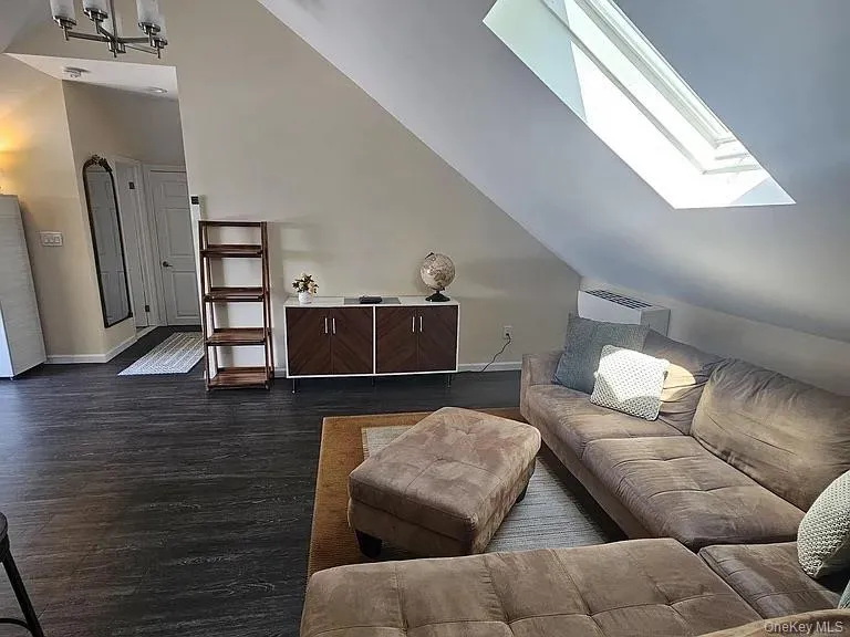 Spacious living room with stunning skylight enveloping the room with natural light. Spacious living room with stunning skylight enveloping the room with natural light.