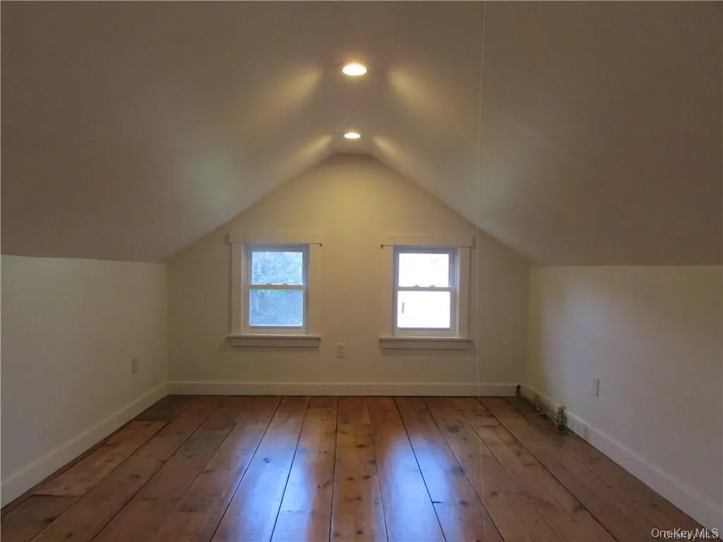 primary bedroom featuring original wide plank floors primary bedroom featuring original wide plank floors