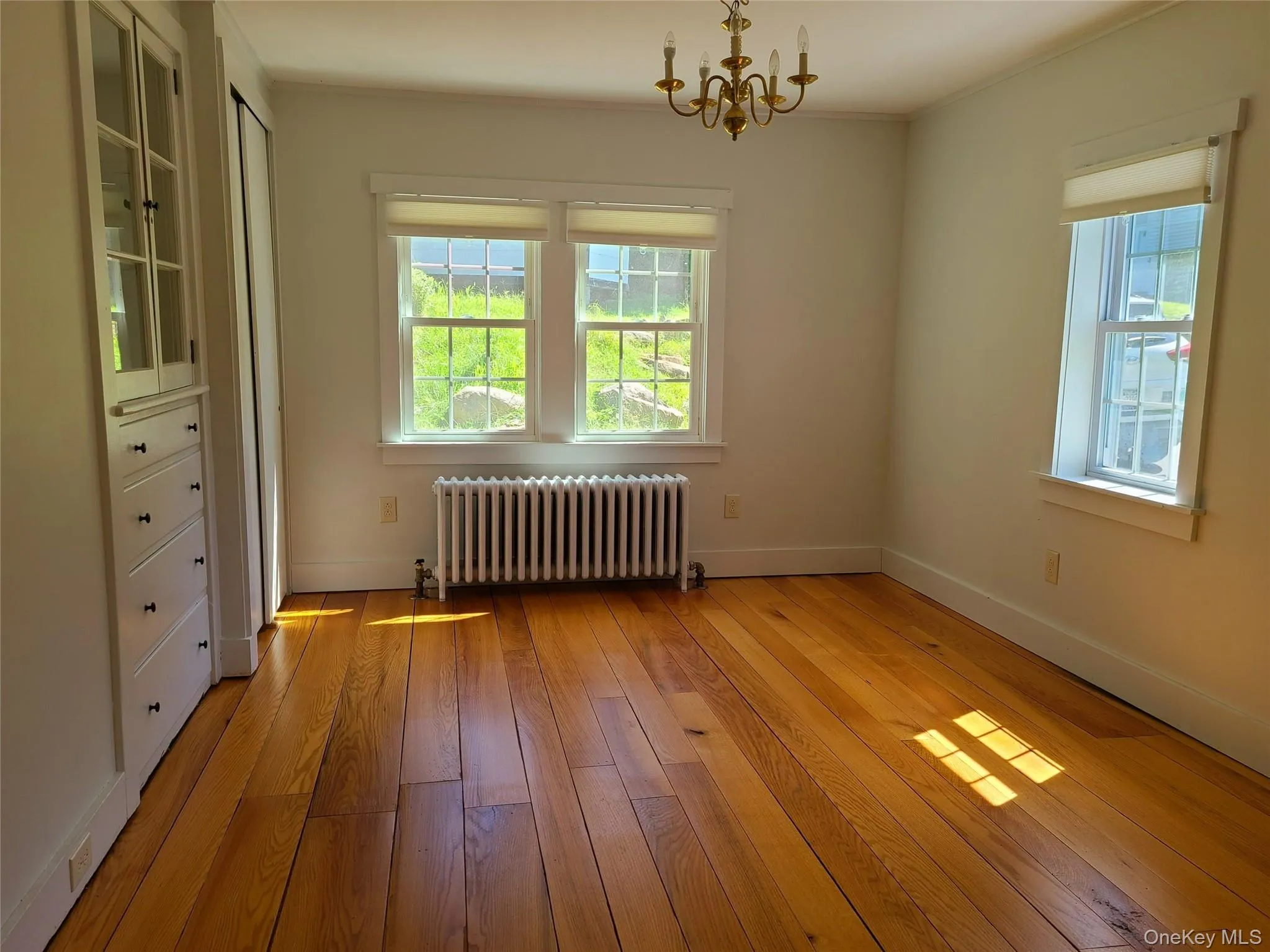 dining room featuring original hardwood floors and built in drawers and cabinets dining room featuring original hardwood floors and built in drawers and cabinets