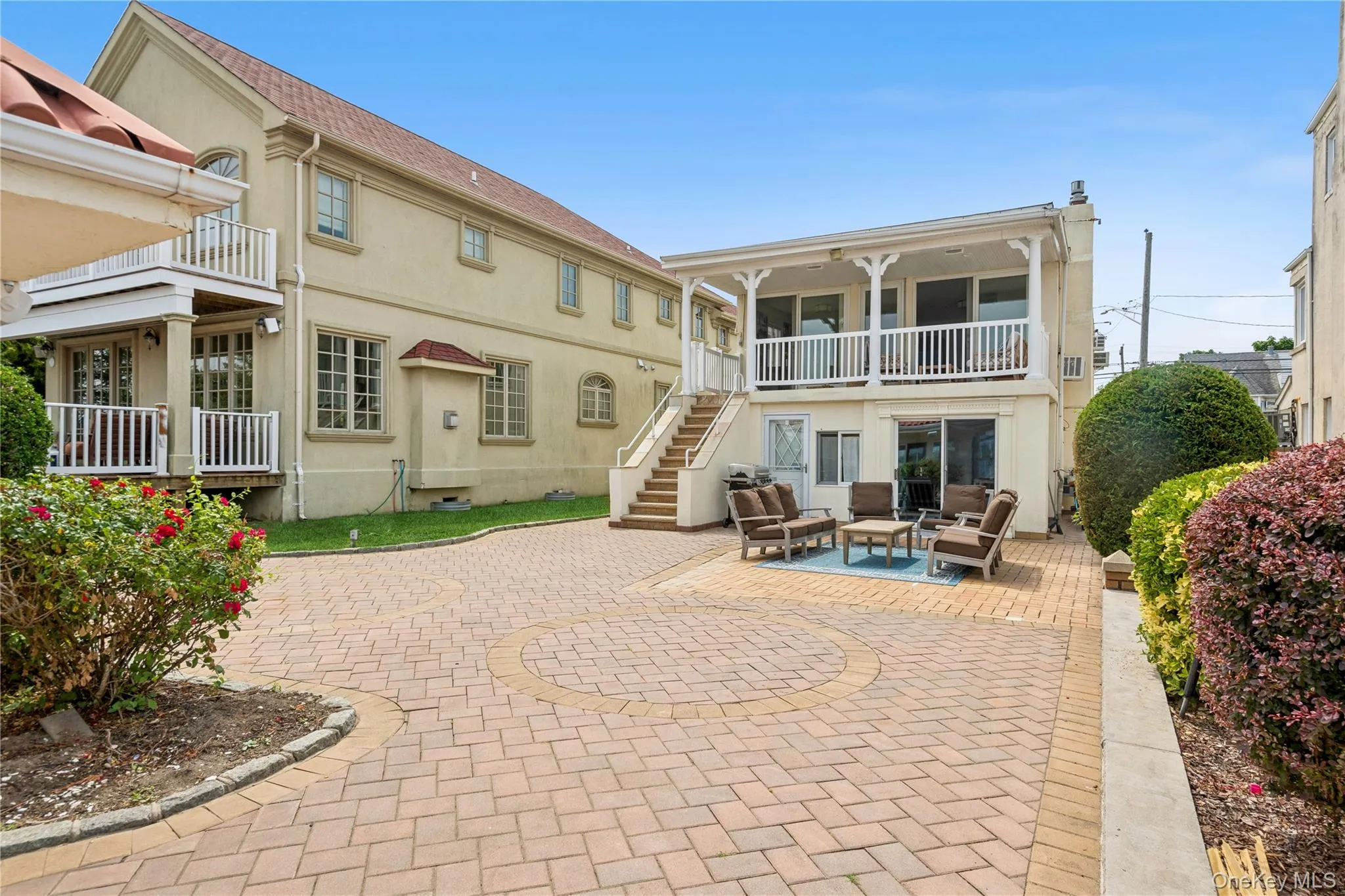Rear view of house with a balcony, an outdoor hangout area, and a patio area Rear view of house with a balcony, an outdoor hangout area, and a patio area