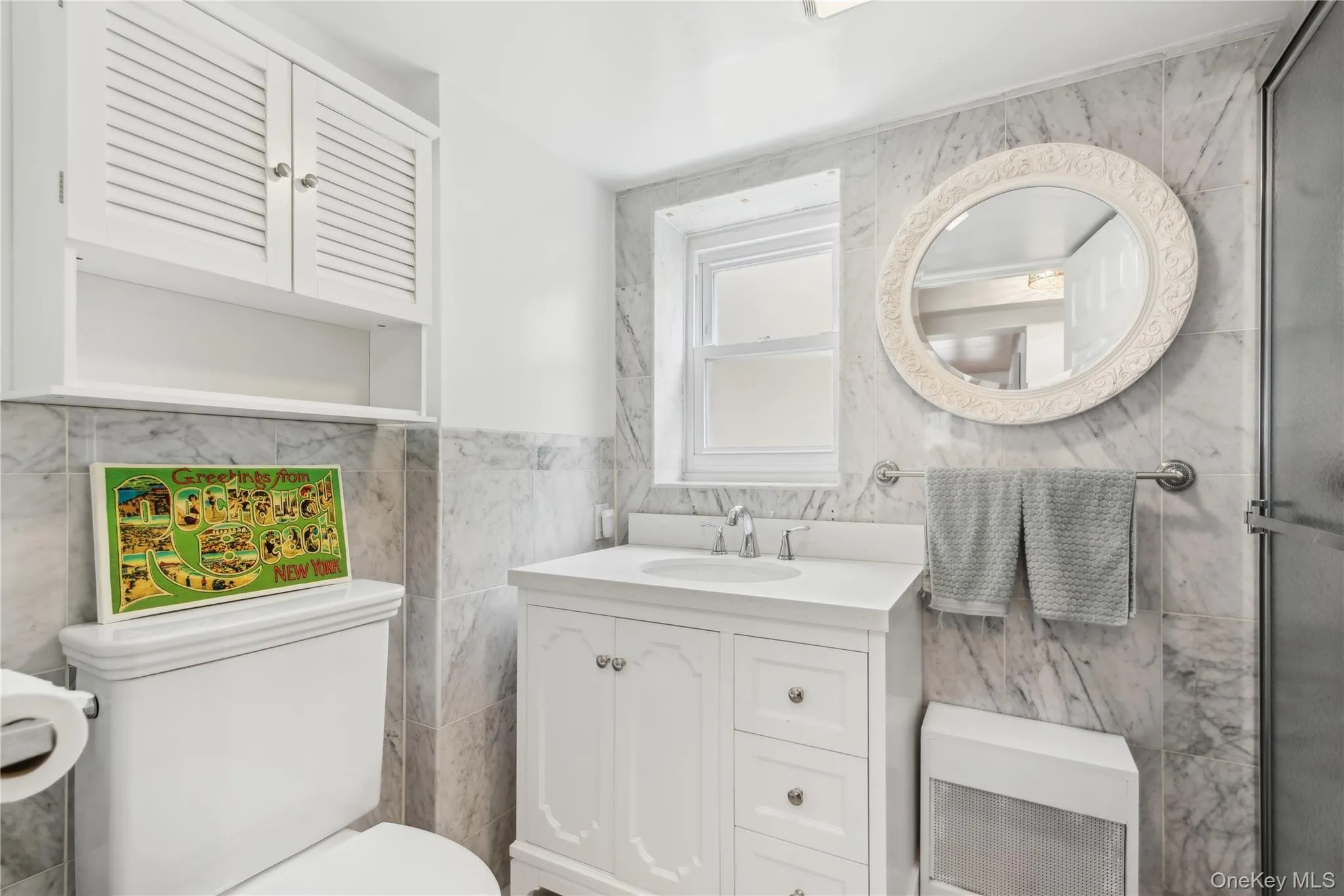 Bathroom with vanity, toilet, and tile walls Bathroom with vanity, toilet, and tile walls