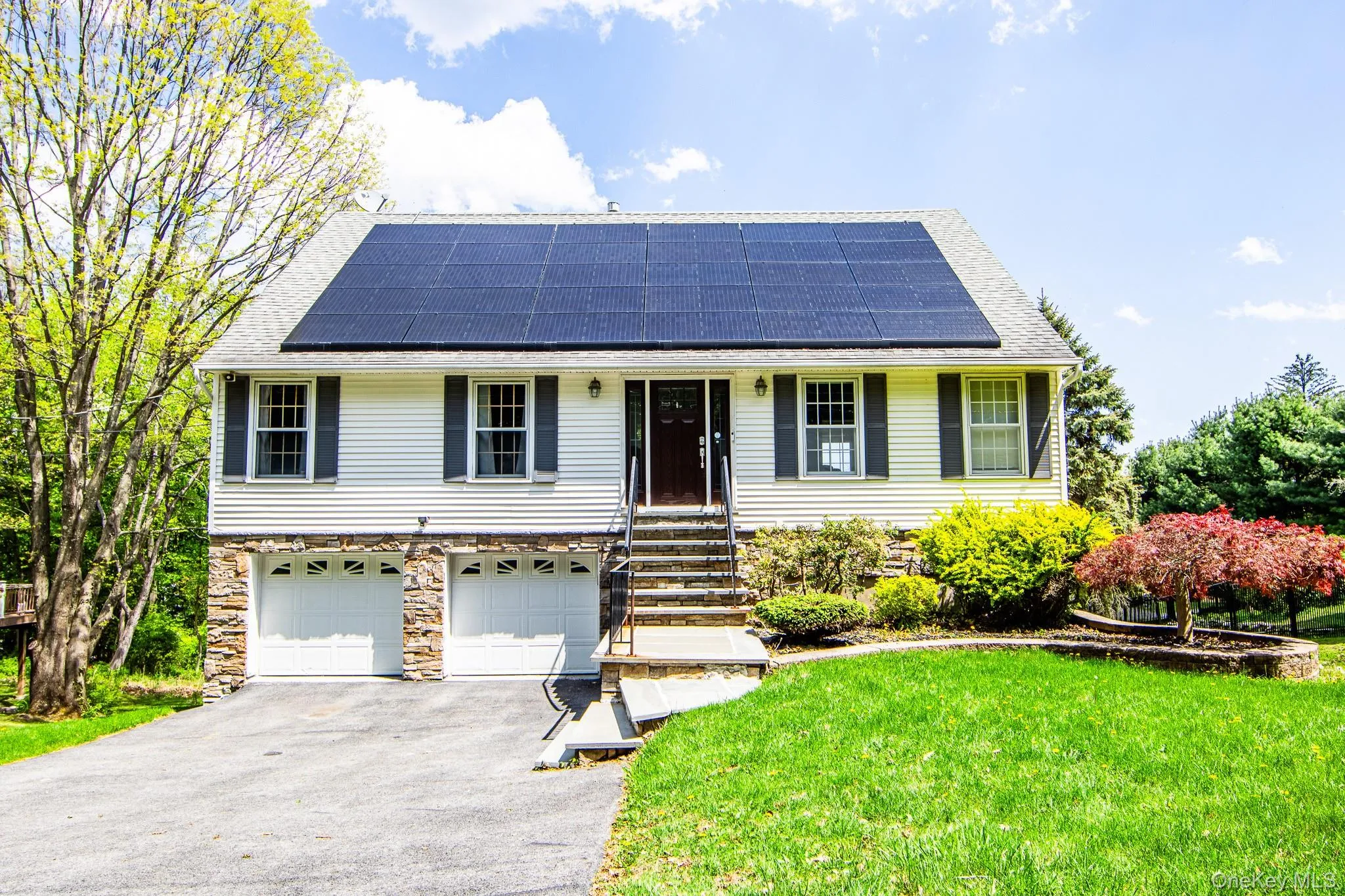 Contemporary cape with vinyl and stone front Contemporary cape with vinyl and stone front