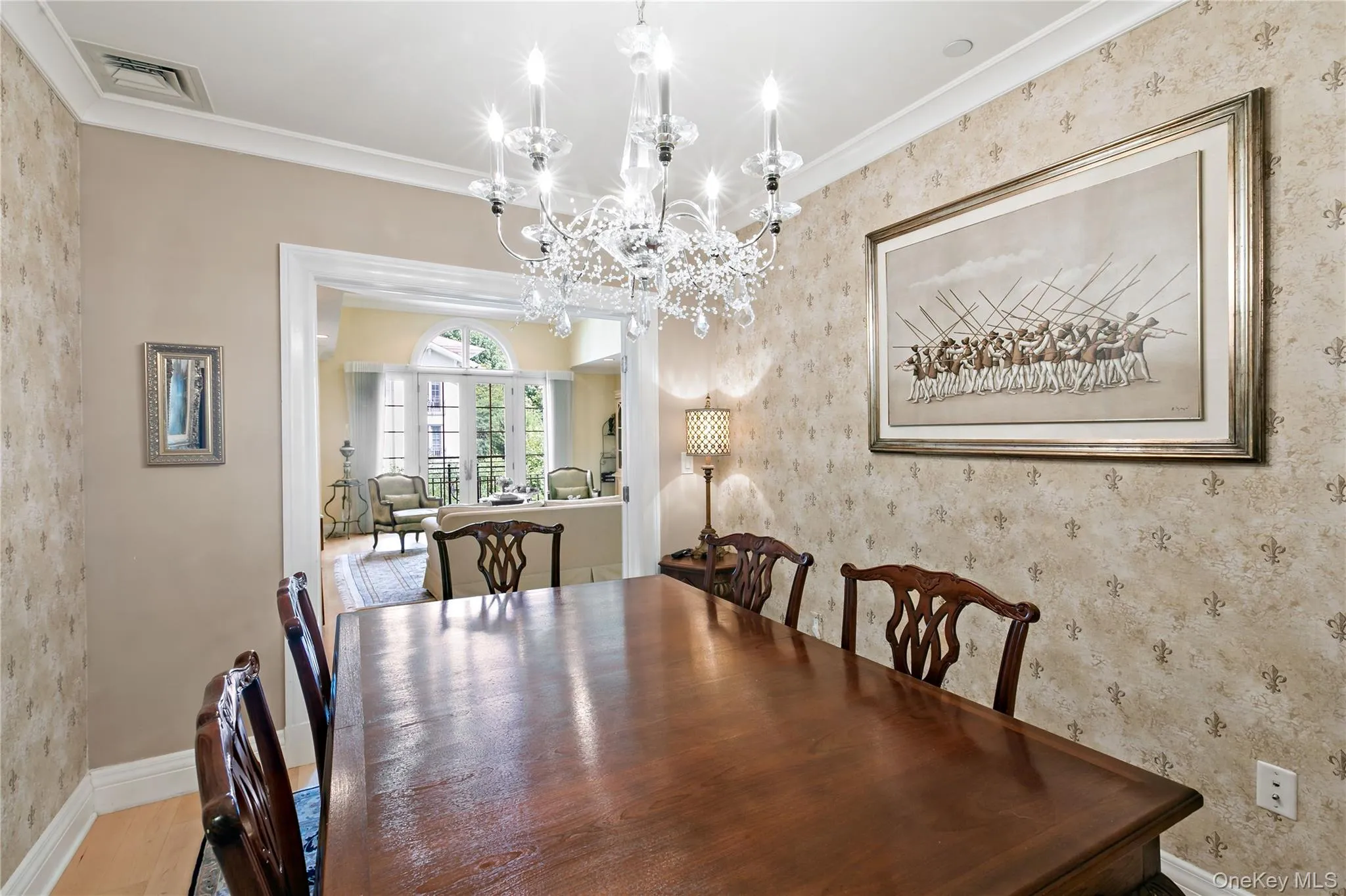 An elegant dining room with chandelier lighting and plenty of room to gather. An elegant dining room with chandelier lighting and plenty of room to gather.