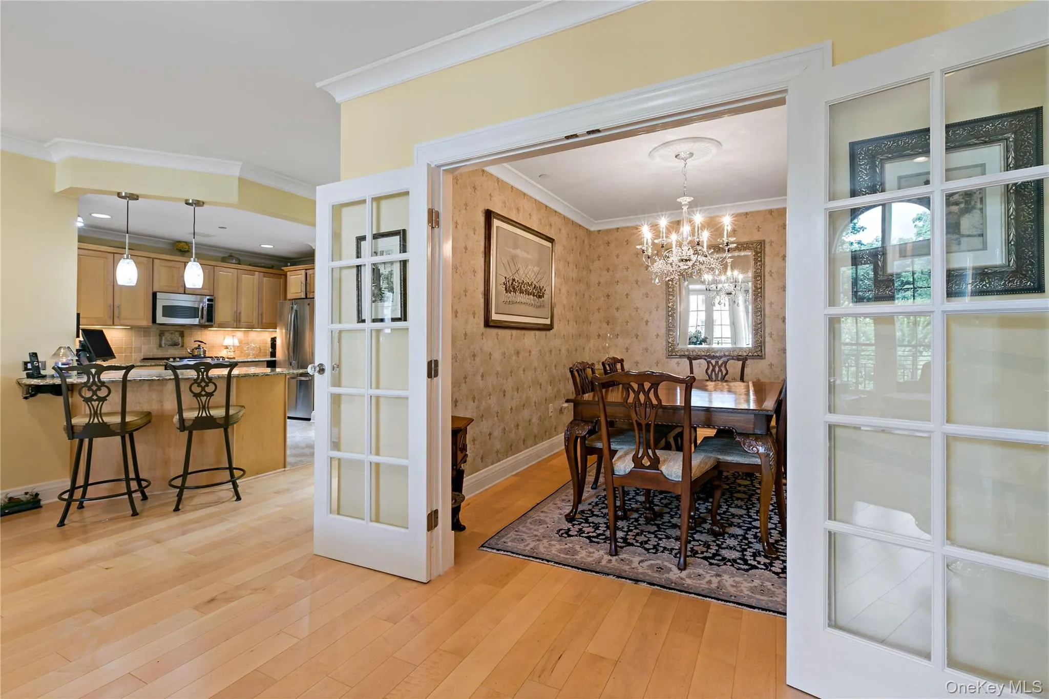 French doors open to a separate dining room, perfect for intimate dinners or entertaining. French doors open to a separate dining room, perfect for intimate dinners or entertaining.