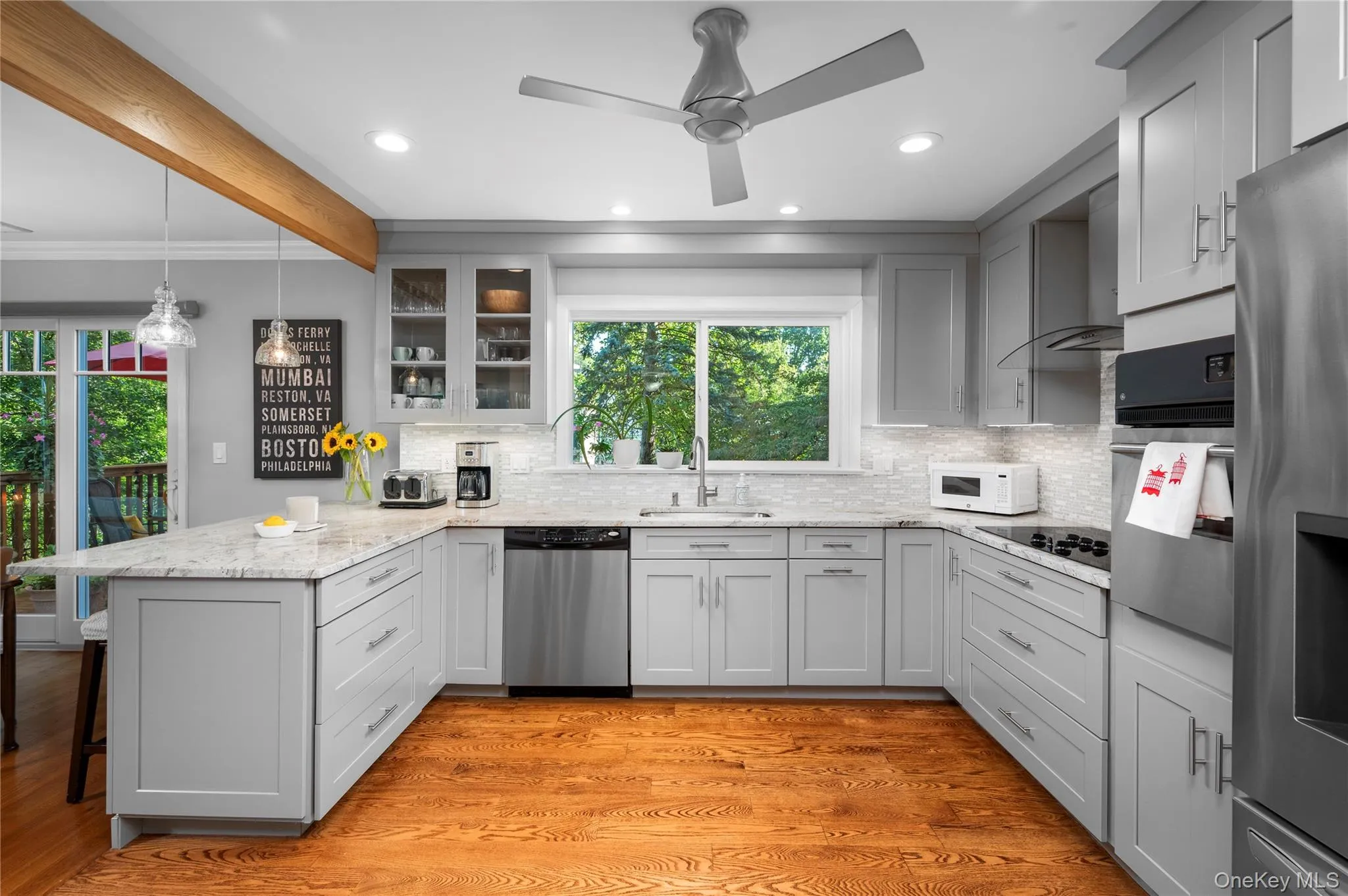 Bright, open-concept kitchen featuring recessed lighting, a garbage disposal, and a ceiling fan Bright, open-concept kitchen featuring recessed lighting, a garbage disposal, and a ceiling fan