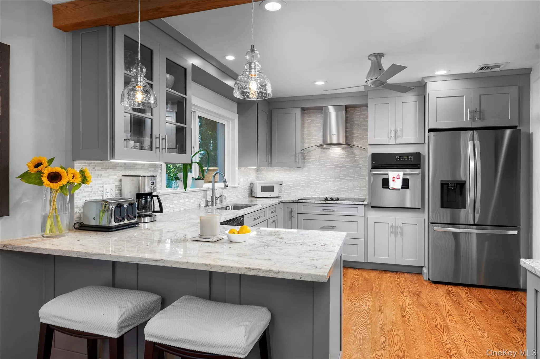 Modern kitchen featuring granite counter-top, stainless steel appliances, hardwood floors Modern kitchen featuring granite counter-top, stainless steel appliances, hardwood floors
