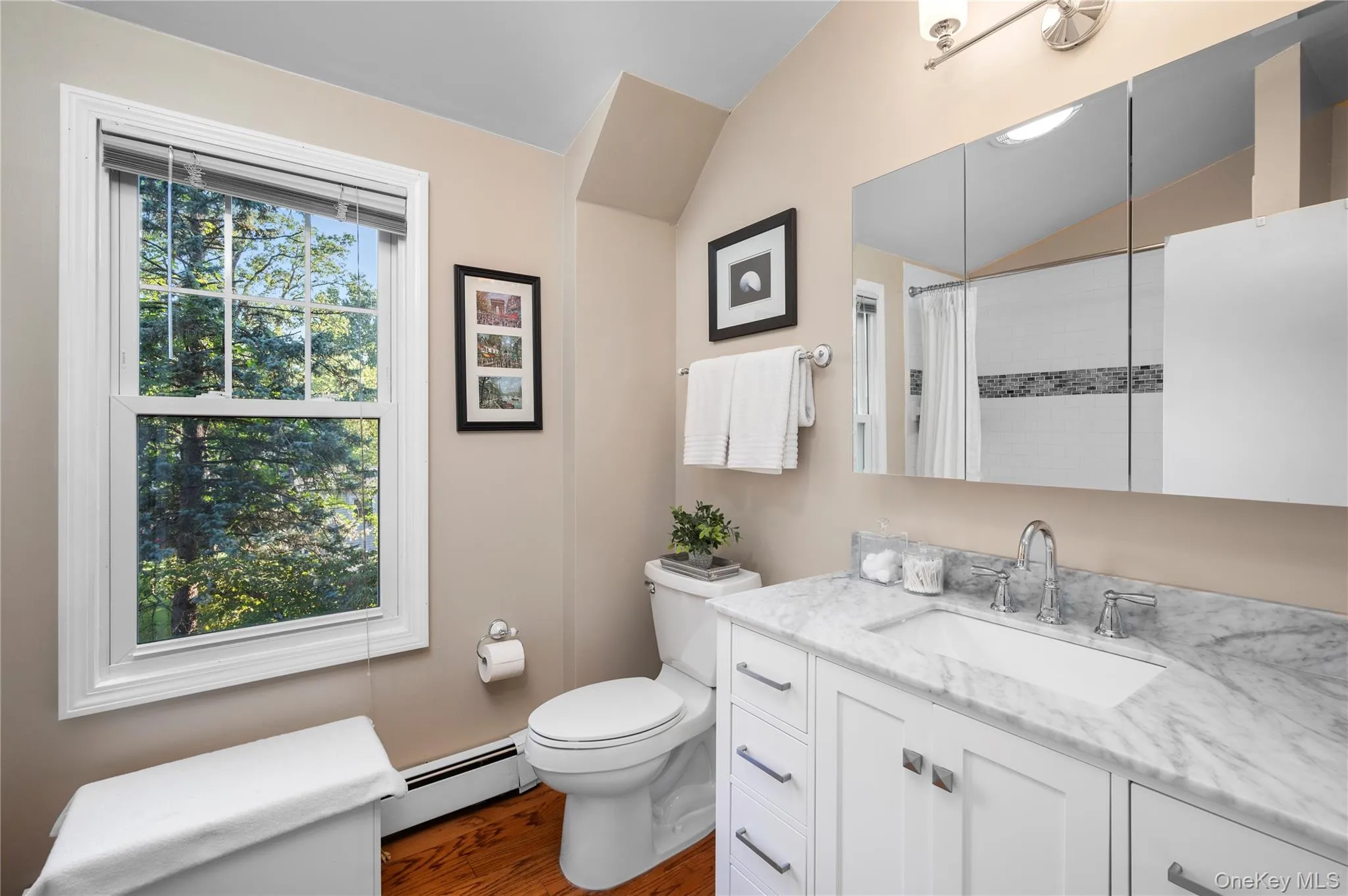 The modern primary bathroom is spacious and well lit. The modern primary bathroom is spacious and well lit.
