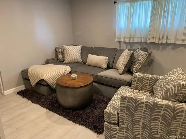 Living area featuring light wood-style floors and baseboards Living area featuring light wood-style floors and baseboards