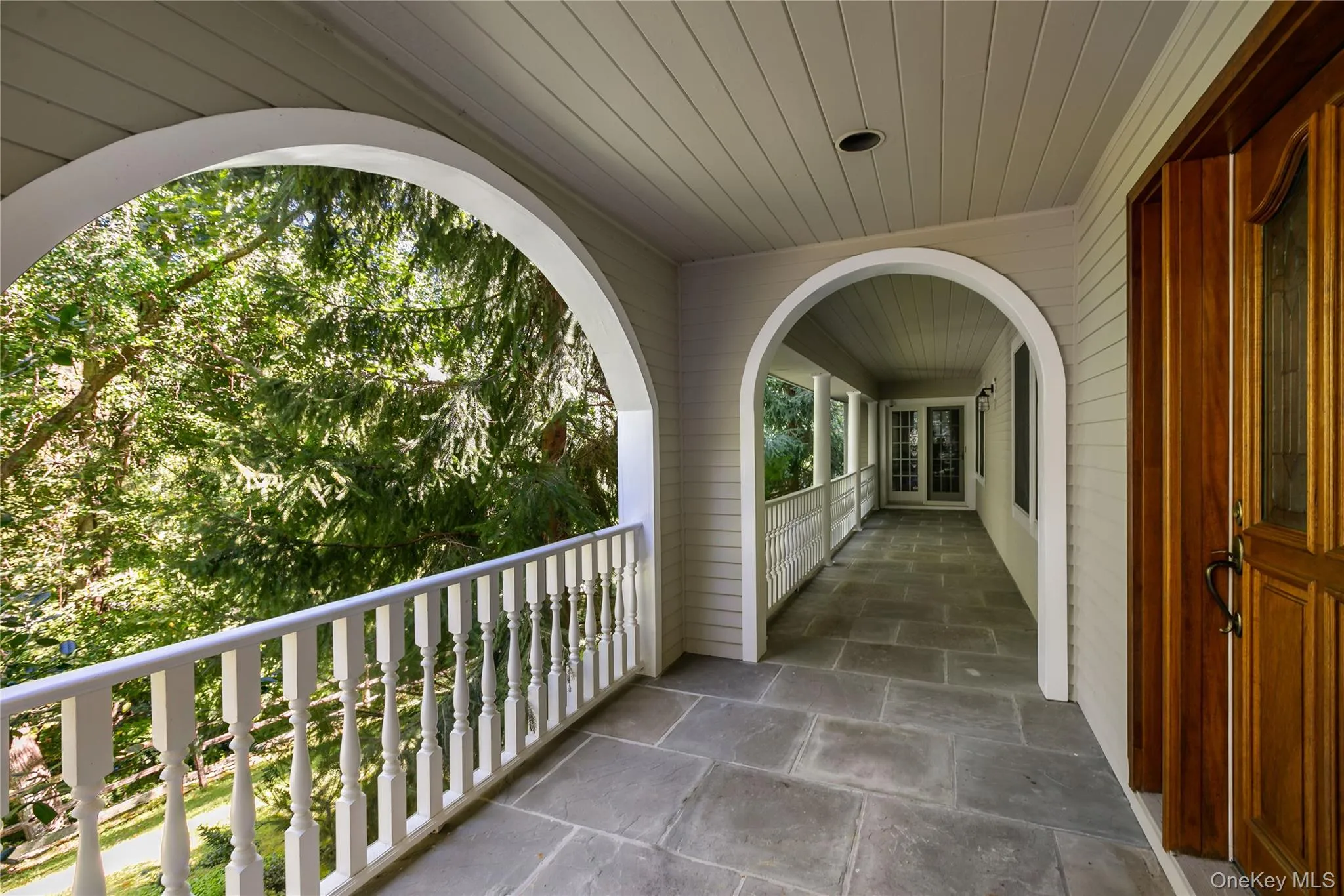 Spectacular front porch showing front entry, bluestone walkway, cedar ceiling, doors to living room Spectacular front porch showing front entry, bluestone walkway, cedar ceiling, doors to living room