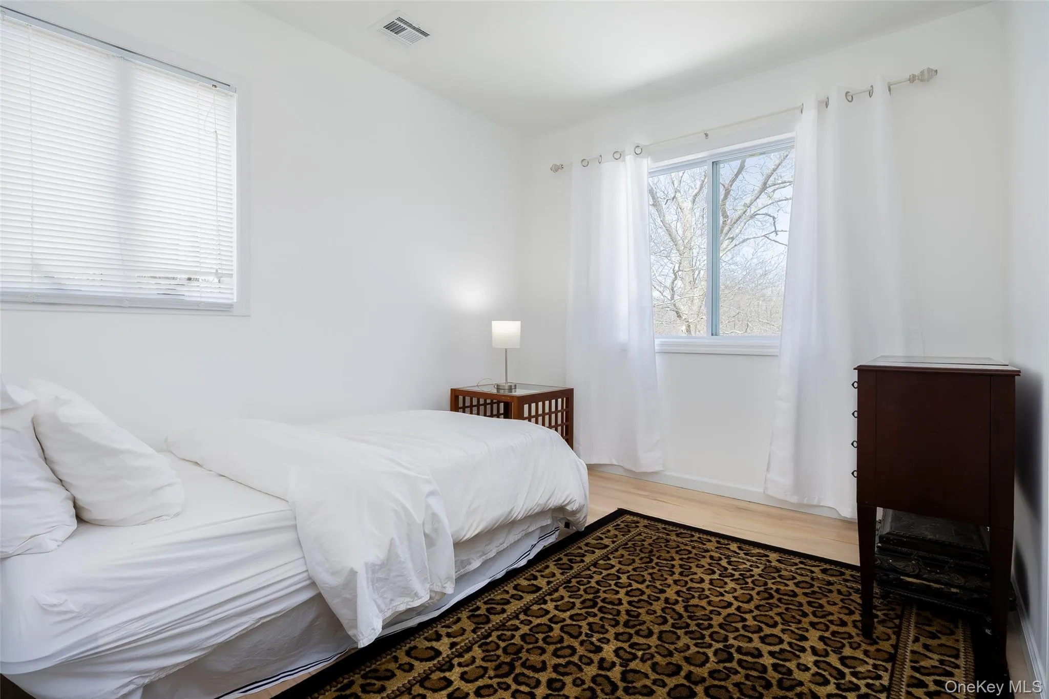 Bedroom featuring wood finished floors Bedroom featuring wood finished floors