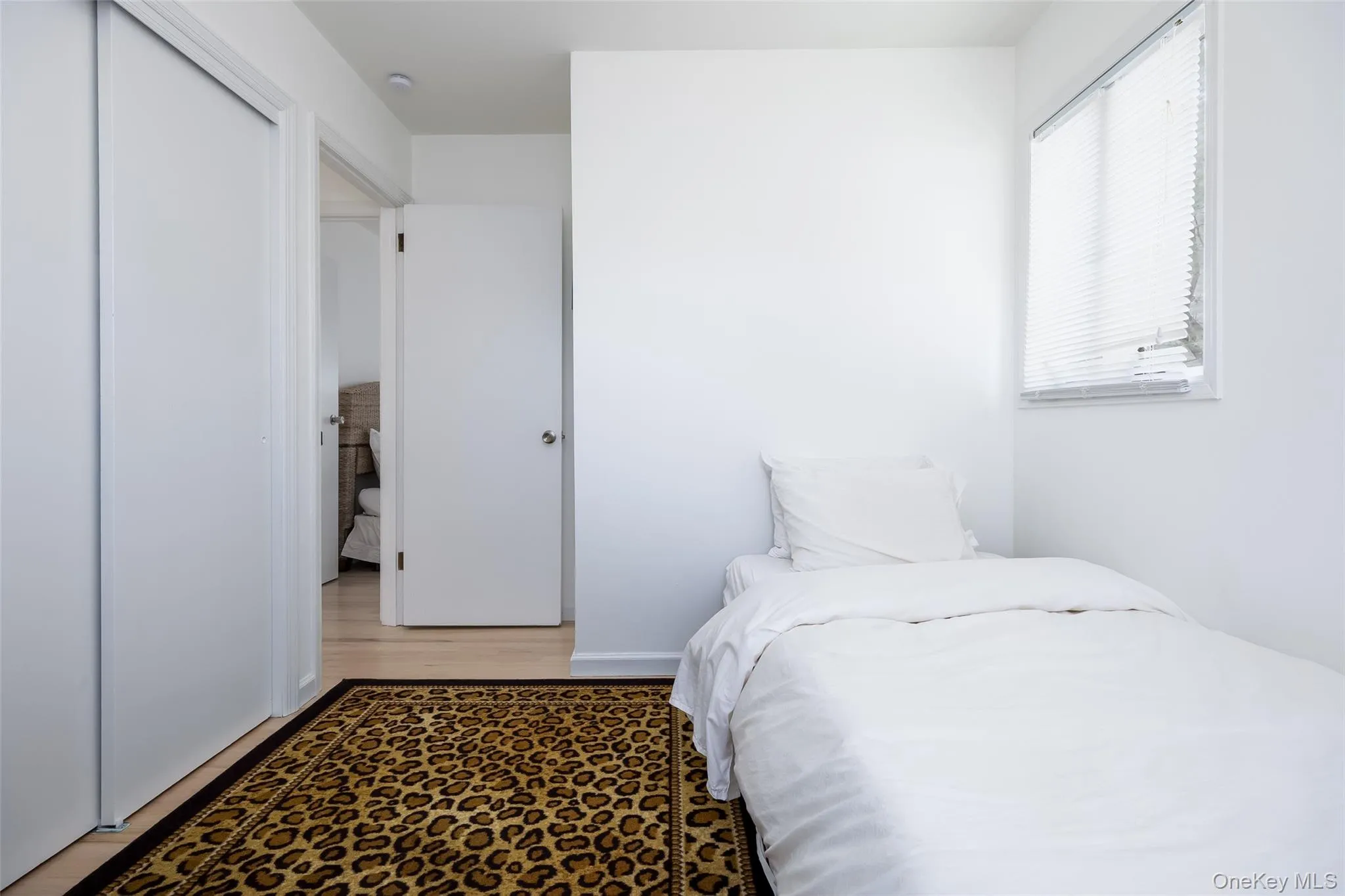 Bedroom featuring light wood-style flooring and a closet Bedroom featuring light wood-style flooring and a closet