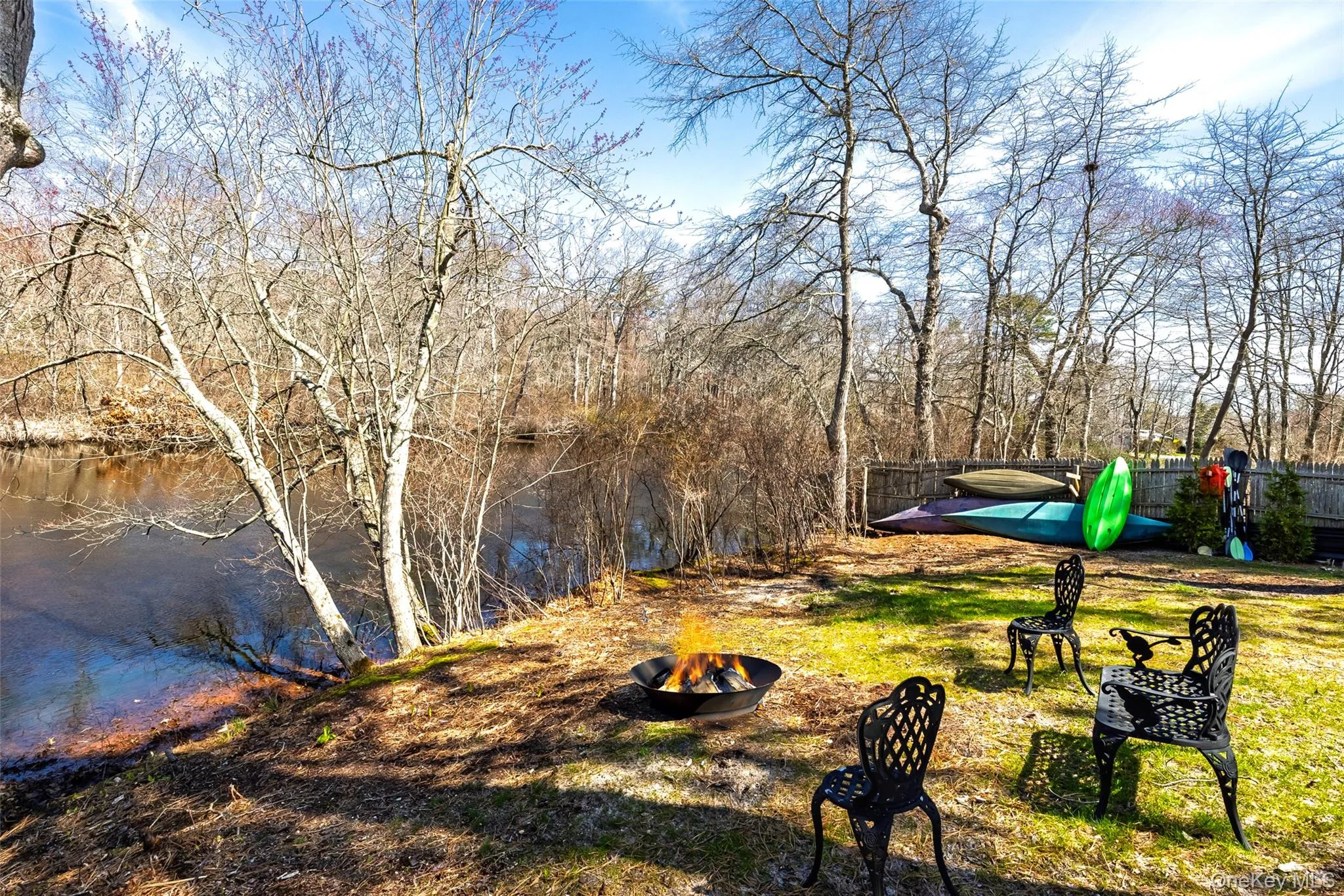 View of yard with a fire pit and fence View of yard with a fire pit and fence