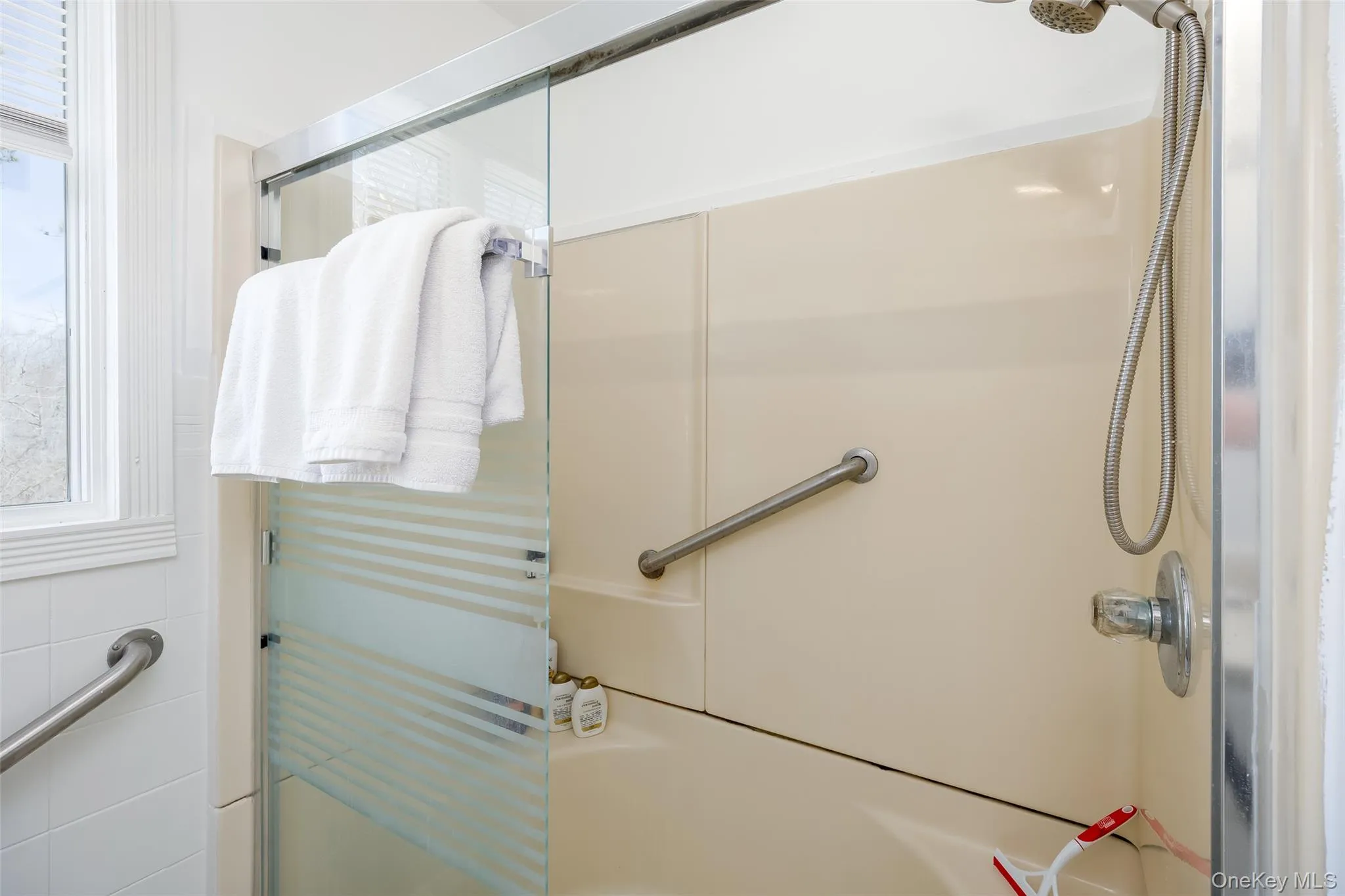 Bathroom with a shower with shower door and healthy amount of natural light Bathroom with a shower with shower door and healthy amount of natural light