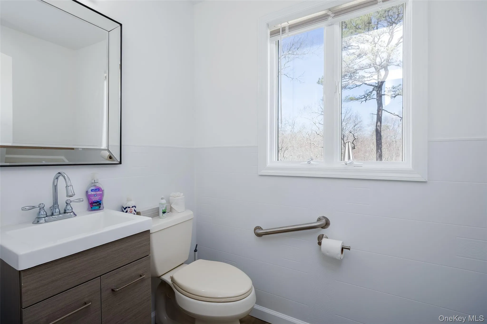 Half bathroom featuring toilet and vanity Half bathroom featuring toilet and vanity