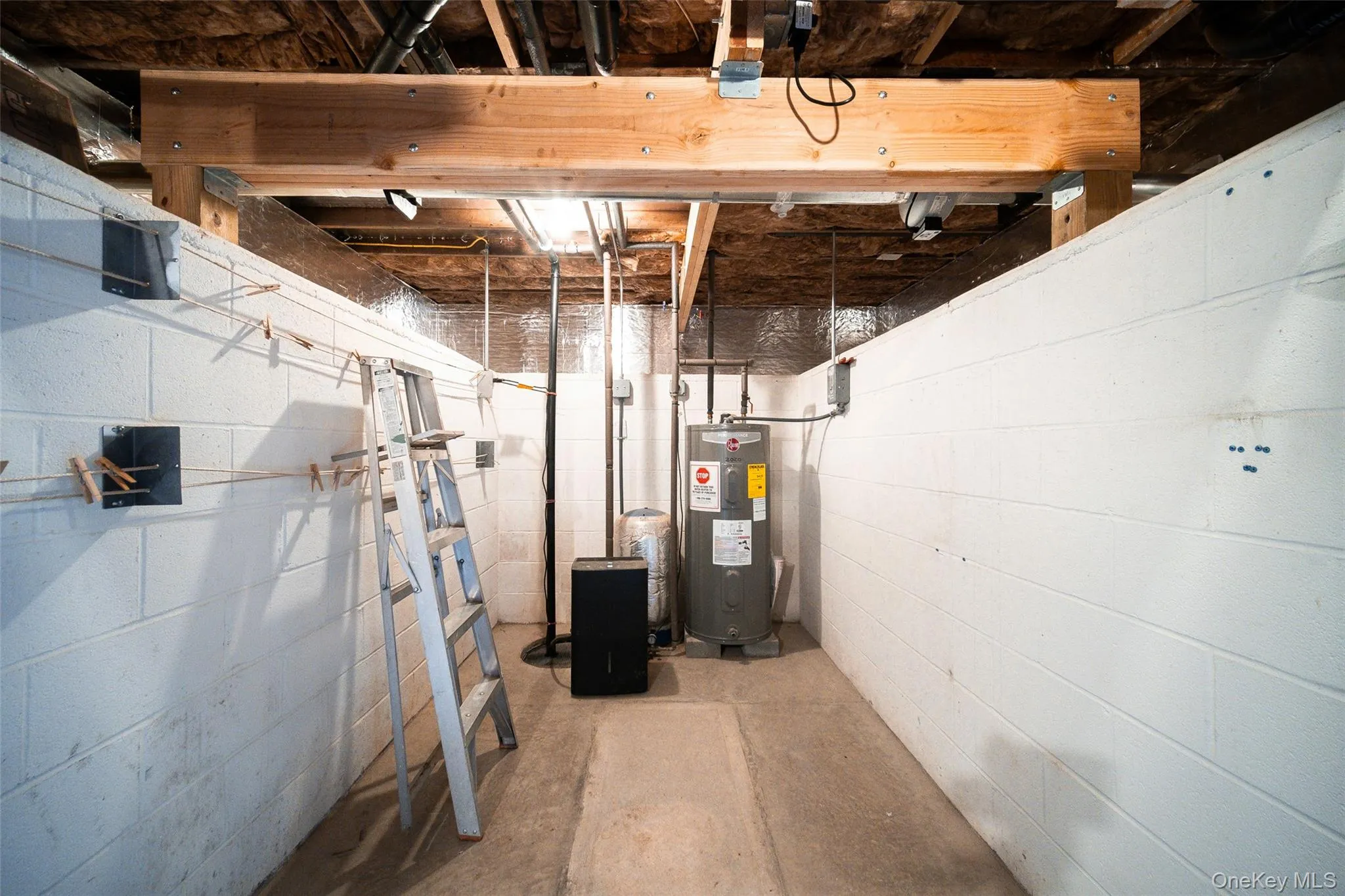 Basement featuring electric water heater Basement featuring electric water heater