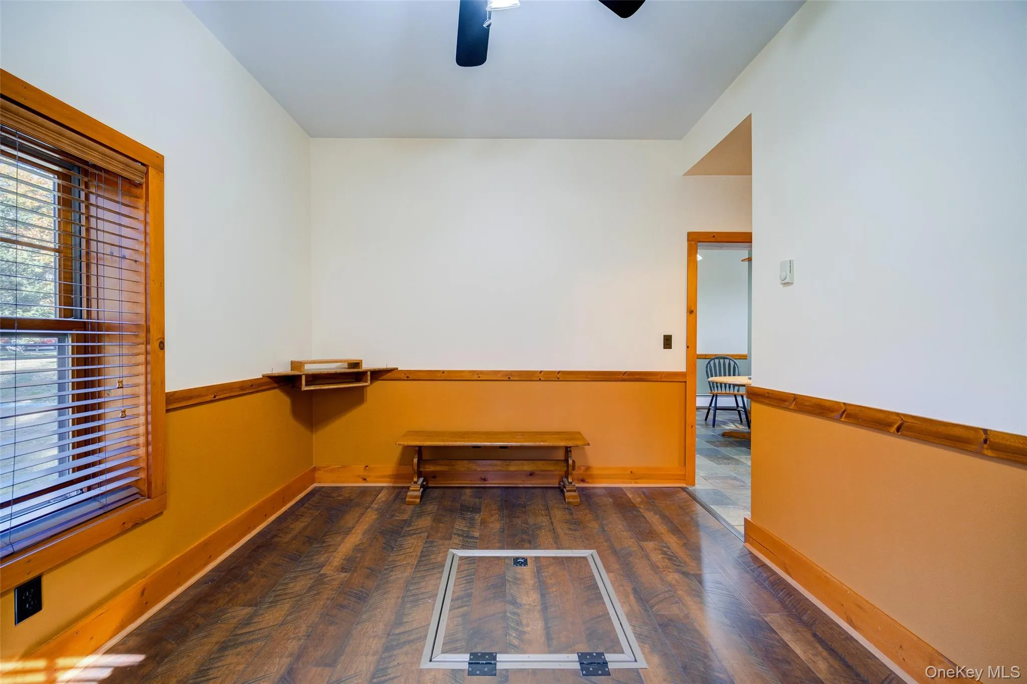 Empty room featuring dark hardwood / wood-style flooring and ceiling fan Empty room featuring dark hardwood / wood-style flooring and ceiling fan
